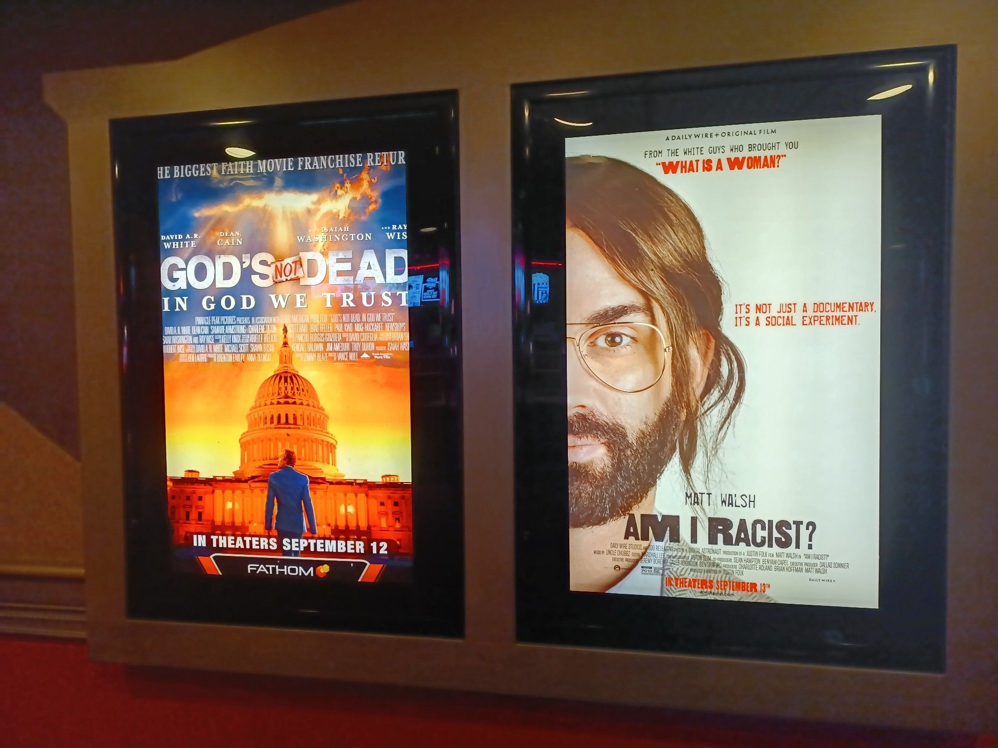 Movie posters for God's Not Dead In God SD Trust and Am I Racist with Matt Walsh wearing a fake looking weave thinking he's a master of disguise.