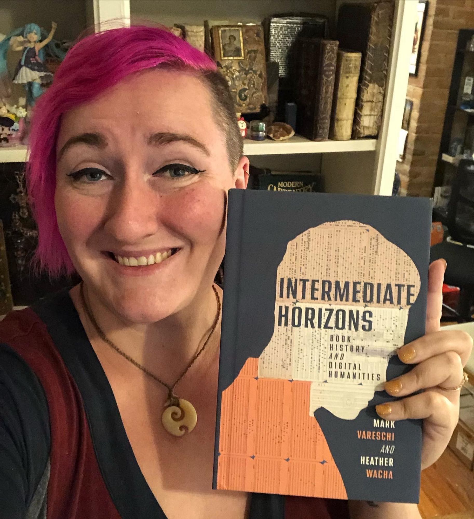 Allie holding a copy of Intermediate Horizons