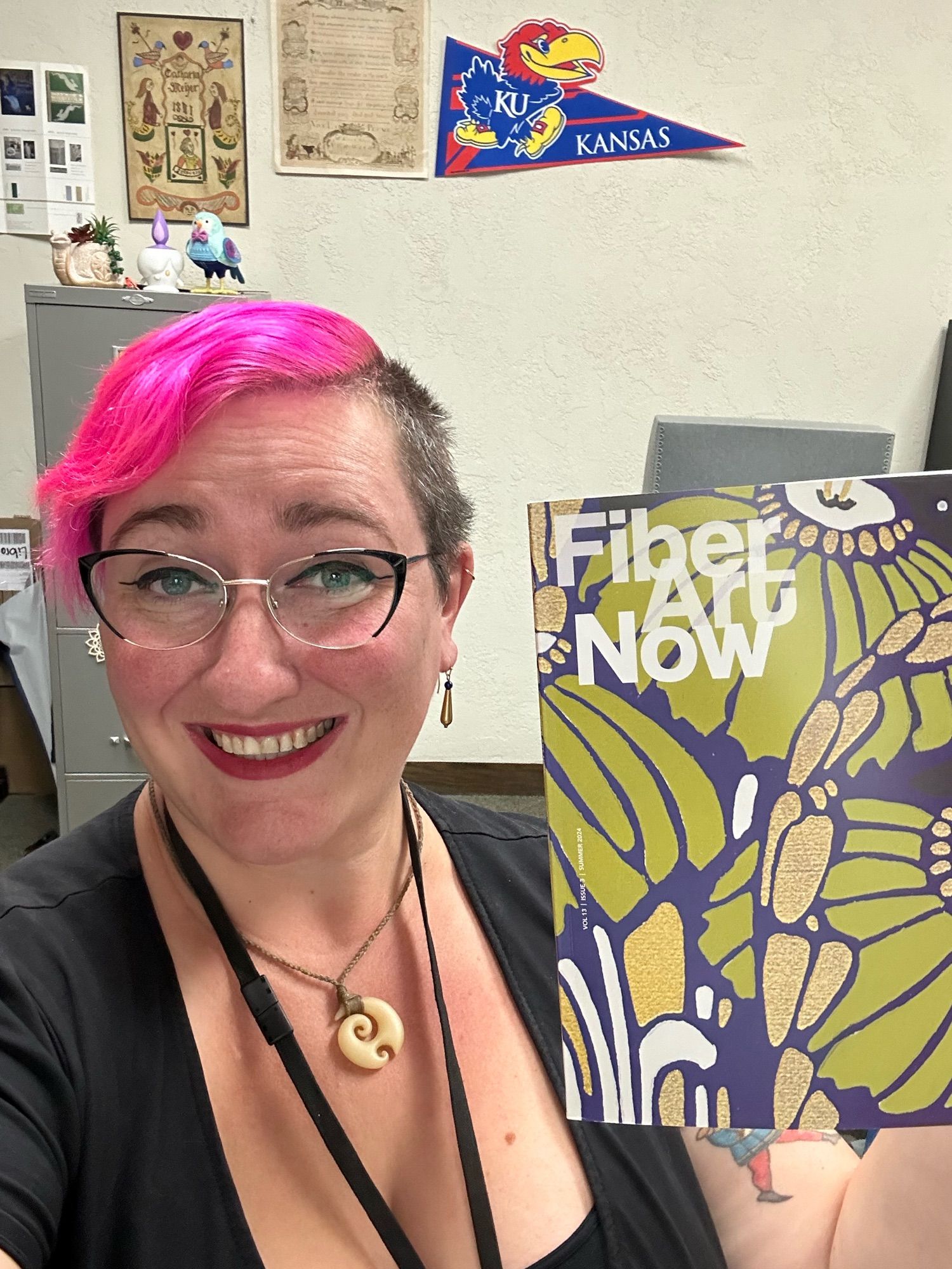 Allie holding a copy of Fiber Art Now