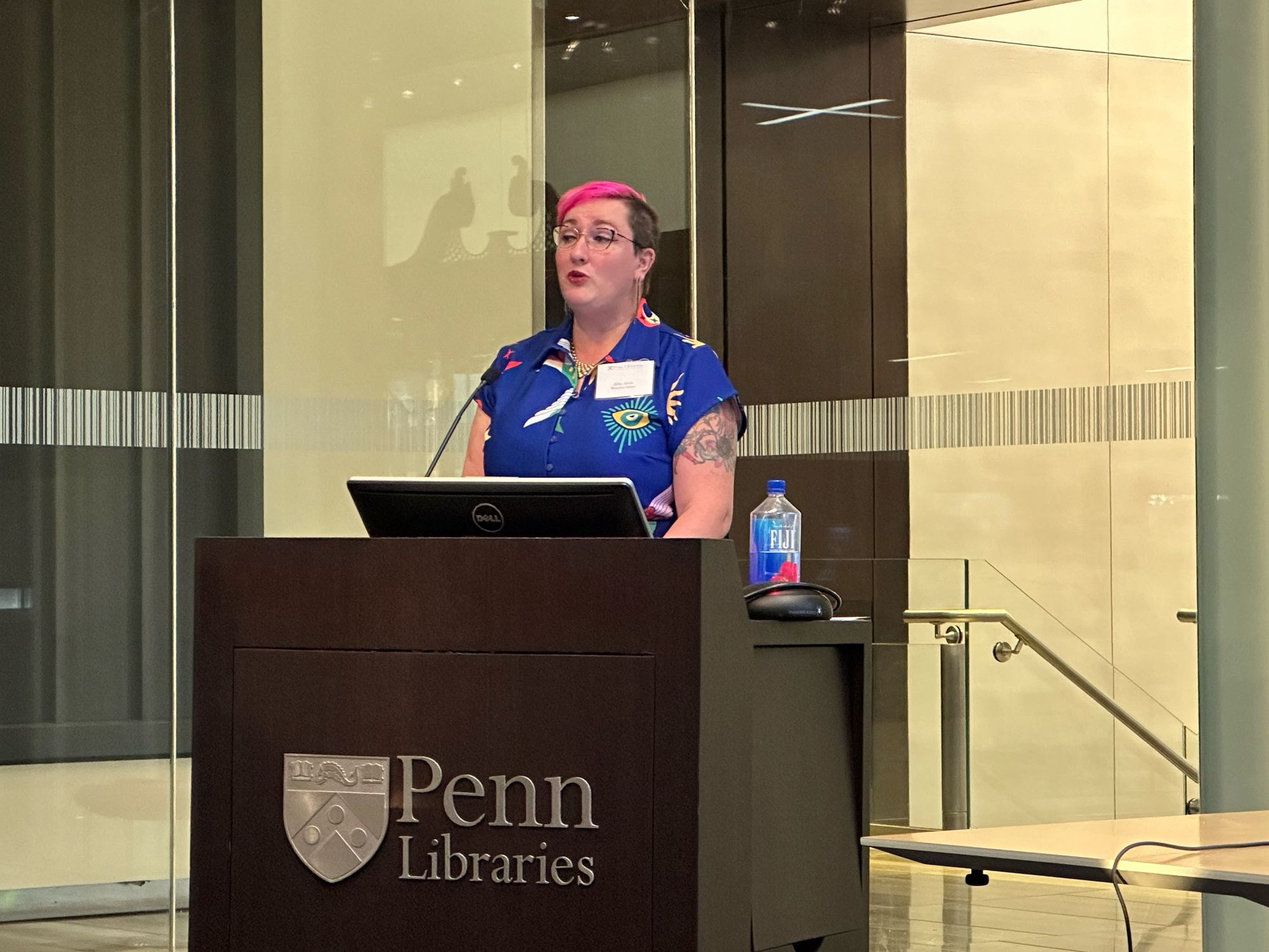 Allie speaking behind a podium at the University of Pennsylvania