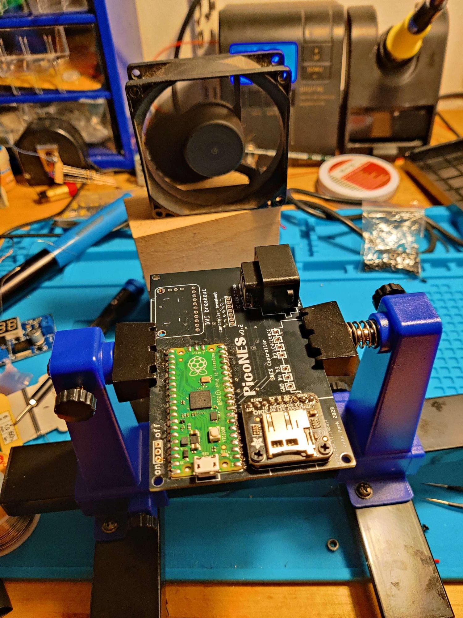 PCB holder with a nearly finished black picoNES PCB