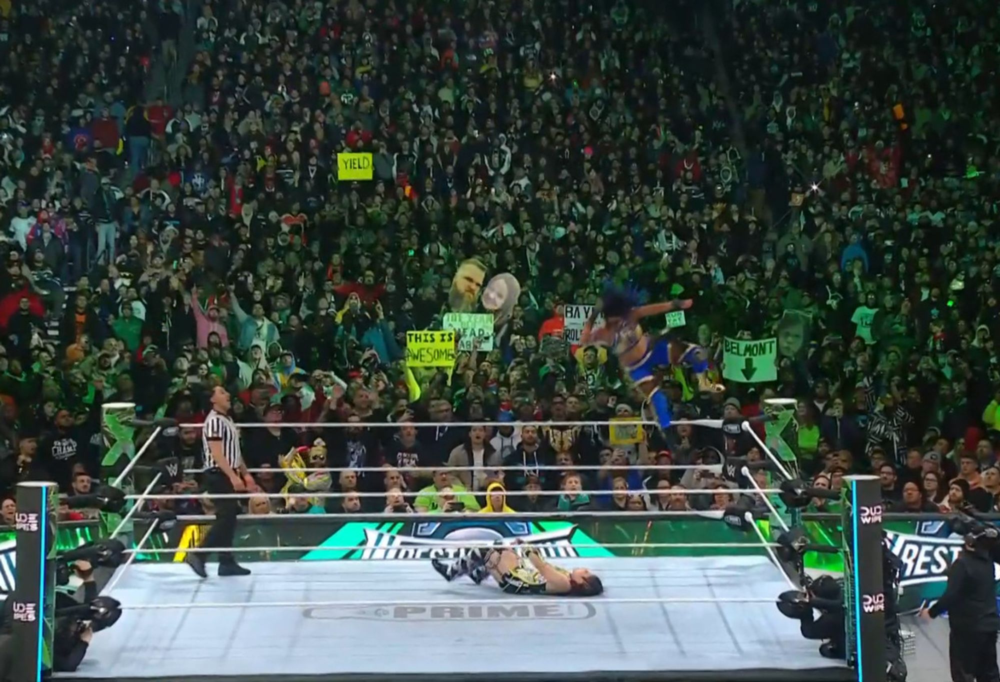 Bayley flys through the air, delivering an elbow drop Macho Man Style to win the Championship against Iyo Sky.