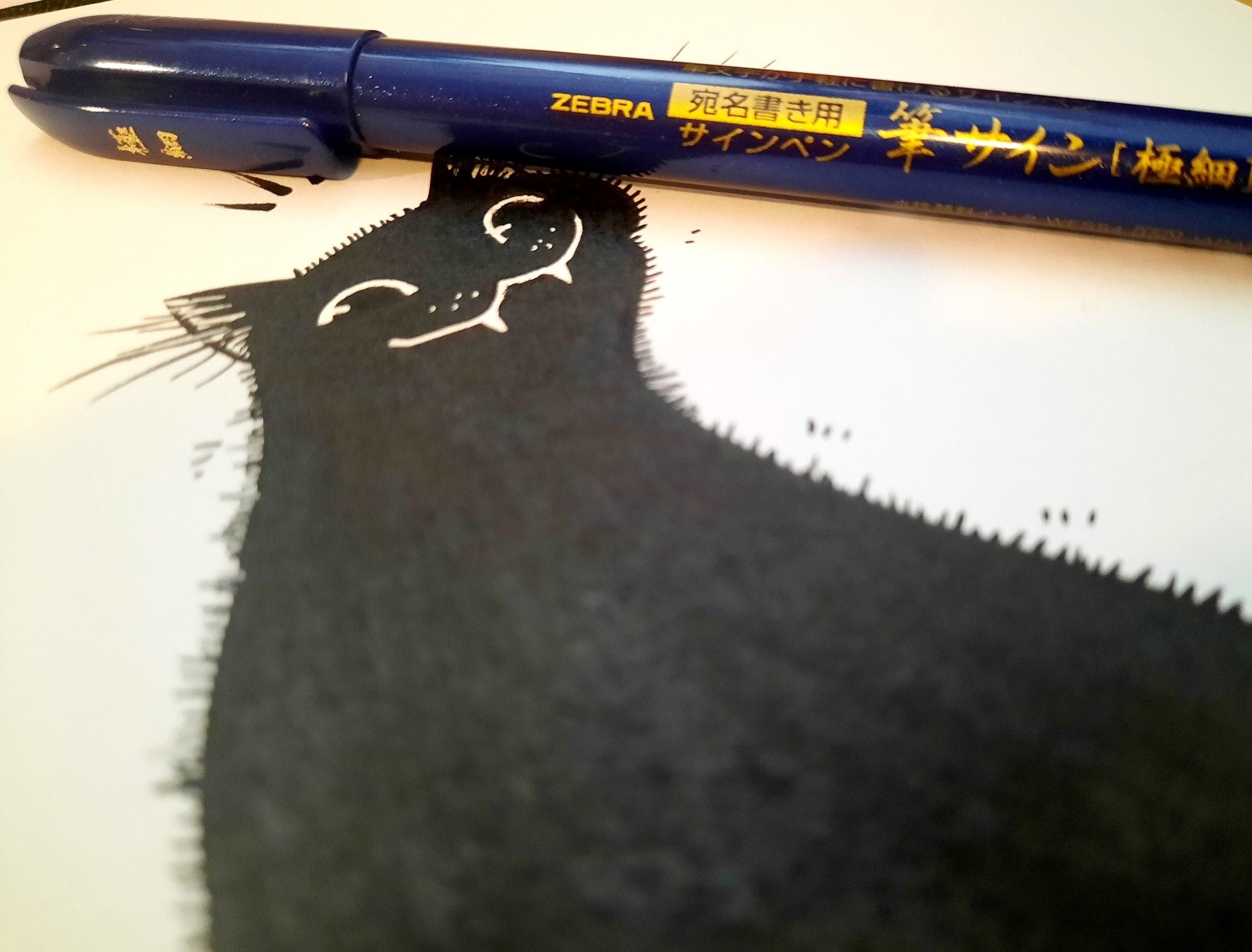 A close-up photo of the same drawing and the main pen used.  Zebra fude sign brush pen.