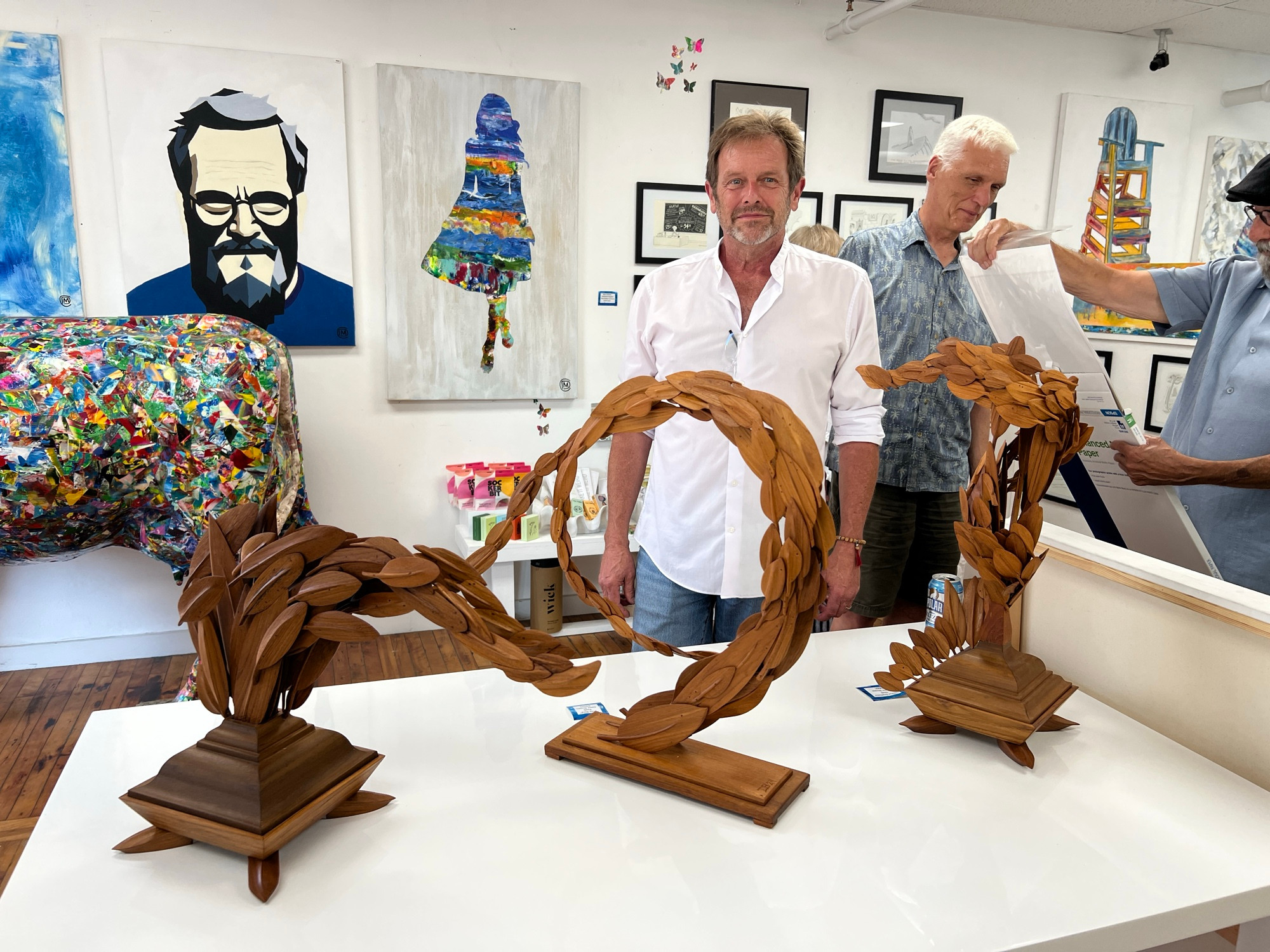 Three sculptures in the gallery with me standing behind.
