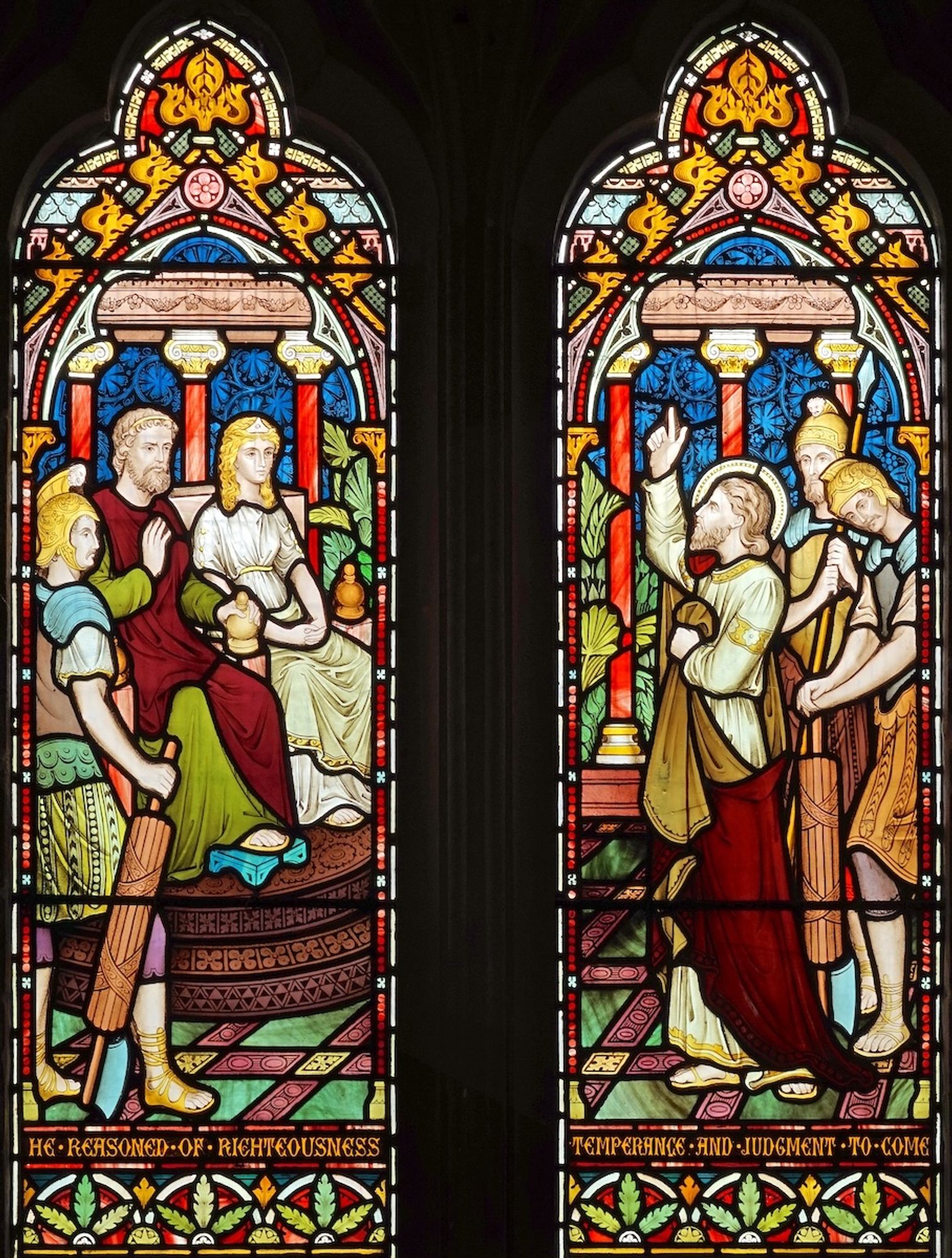 Stained glass in two panels. In the left, Agrippa and Bernice are seated with a Roman soldier, holding the fasces, to their right. In the right hand panel, St. Paul stands, his right hand raised. Behind him stand two Roman soldiers. The floor is richly patterned, and in the background are red-coloured pillars with Corinthian capitals.