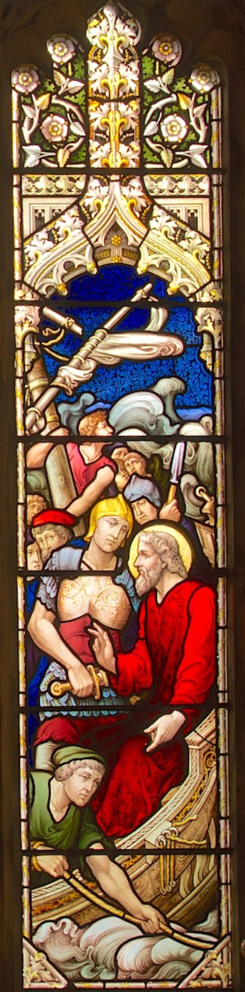 Stained glass panel depicting Saint Paul, dressed in a red robe, on board a ship, in earnest conversation with a Roman centurion who is holding a sword. In front of them a sailor throws a line overboard. Behind them several other sailors are in states of agitation. The ships sail is in tatters overhead and in the background are huge waves and a dark sky.