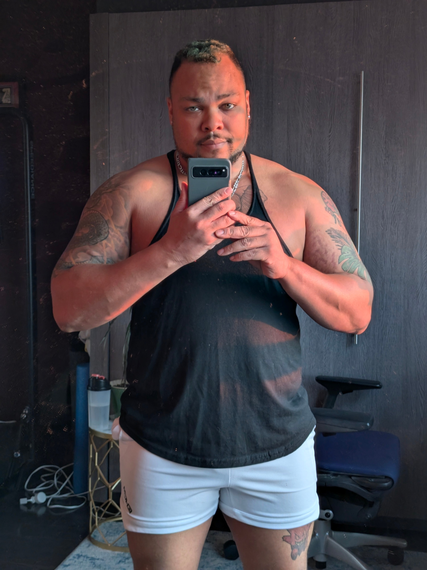 Selfie of me in a mirror wearing a black tank top 