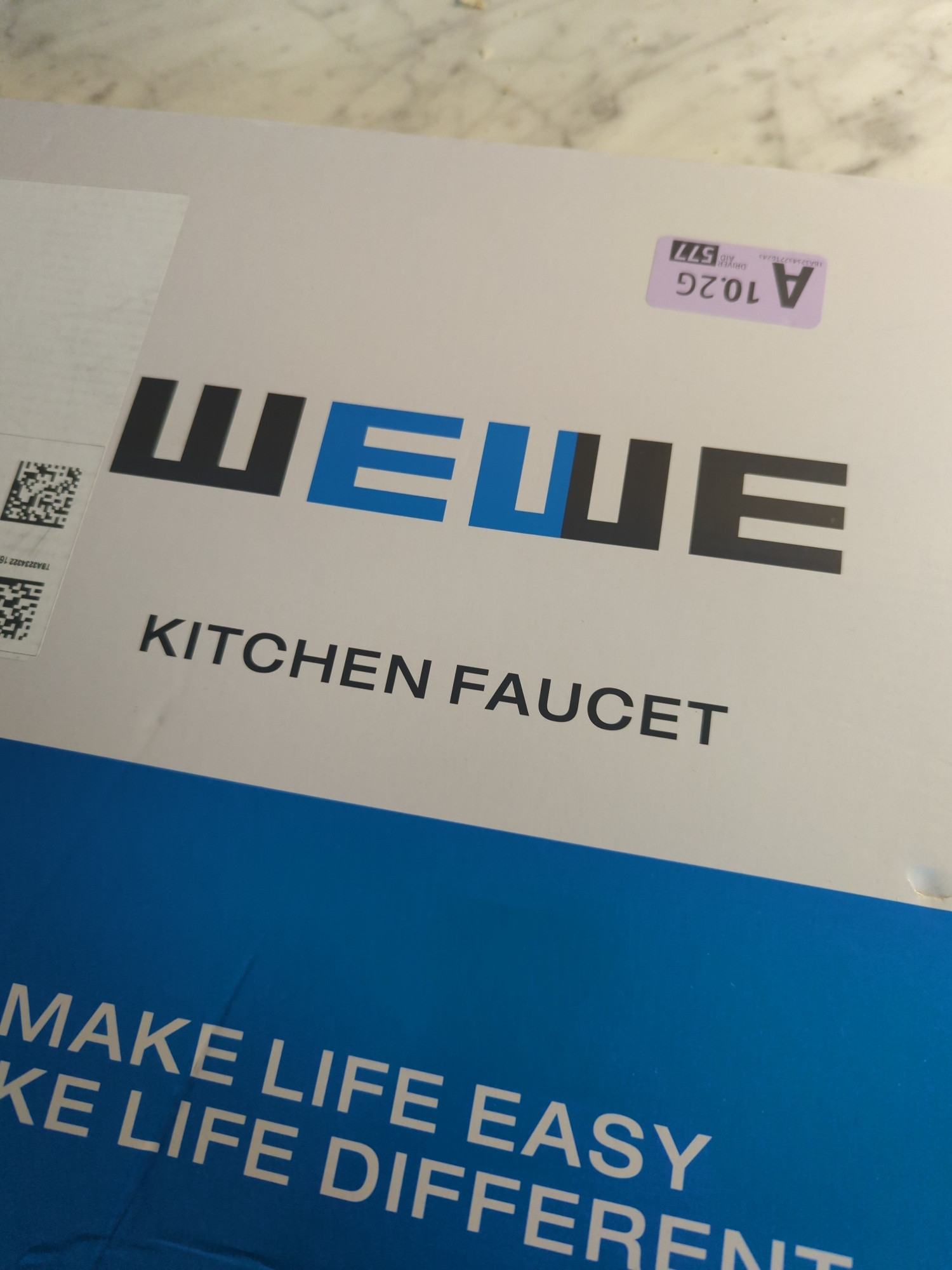 A box for a kitchen faucet that reads "Wewe kitchen faucet. Make life easy make life different" blue and white box with black and blue font on the top white font on the bottom
