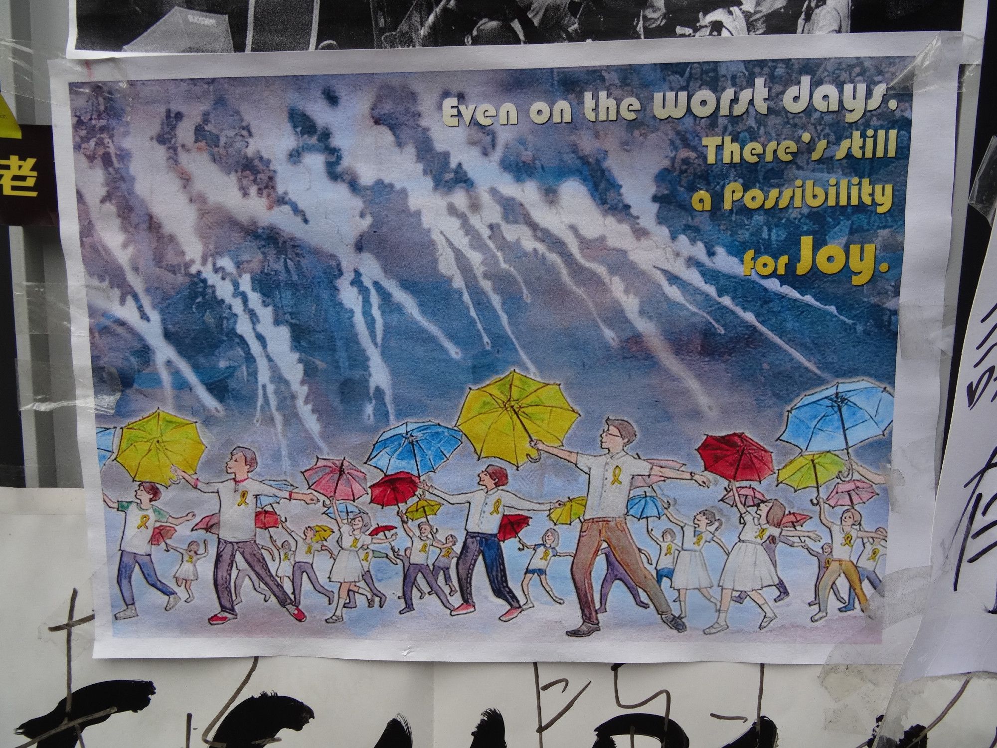 Art work with the words "Even a on the worst days[,] there's still a possibility for Joy" on it along with people holding umbrellas (yellow but also blue, pink and red) and wearing clothing adorned with yellow ribbons to protect themselves from tear gas raining down on them.