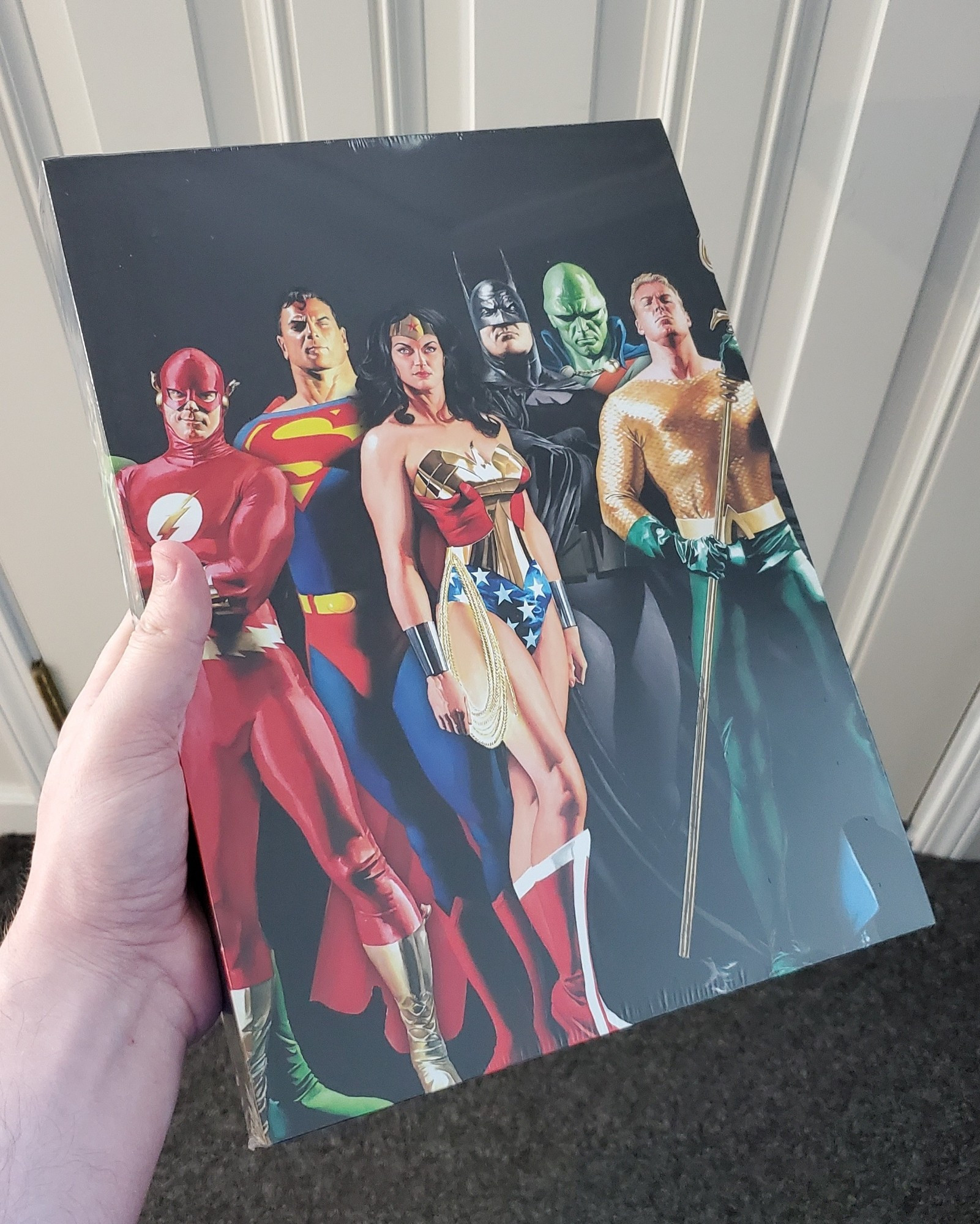 The hardcover special edition of Absolute Justice League: The World's Greatest Super-heroes by Alex Ross and Paul Dini.