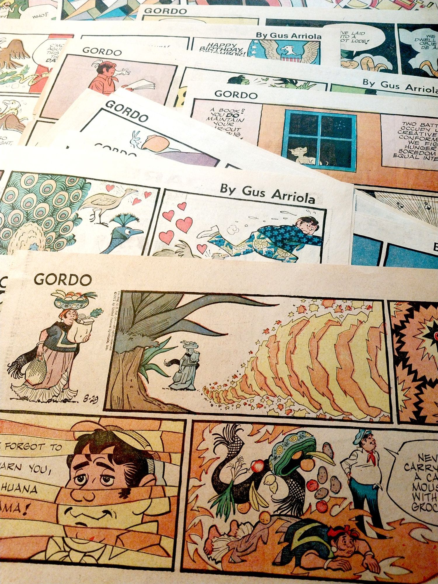 A stack of Gordo Sunday strips from the 1970s and 1980s, displaying the bright colors and dynamic shapes which typified the era.