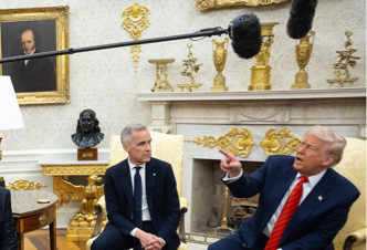 President Trump talking over Prime Minister Carney amid assorted gold-painted knick-knacks all over the Oval Office
