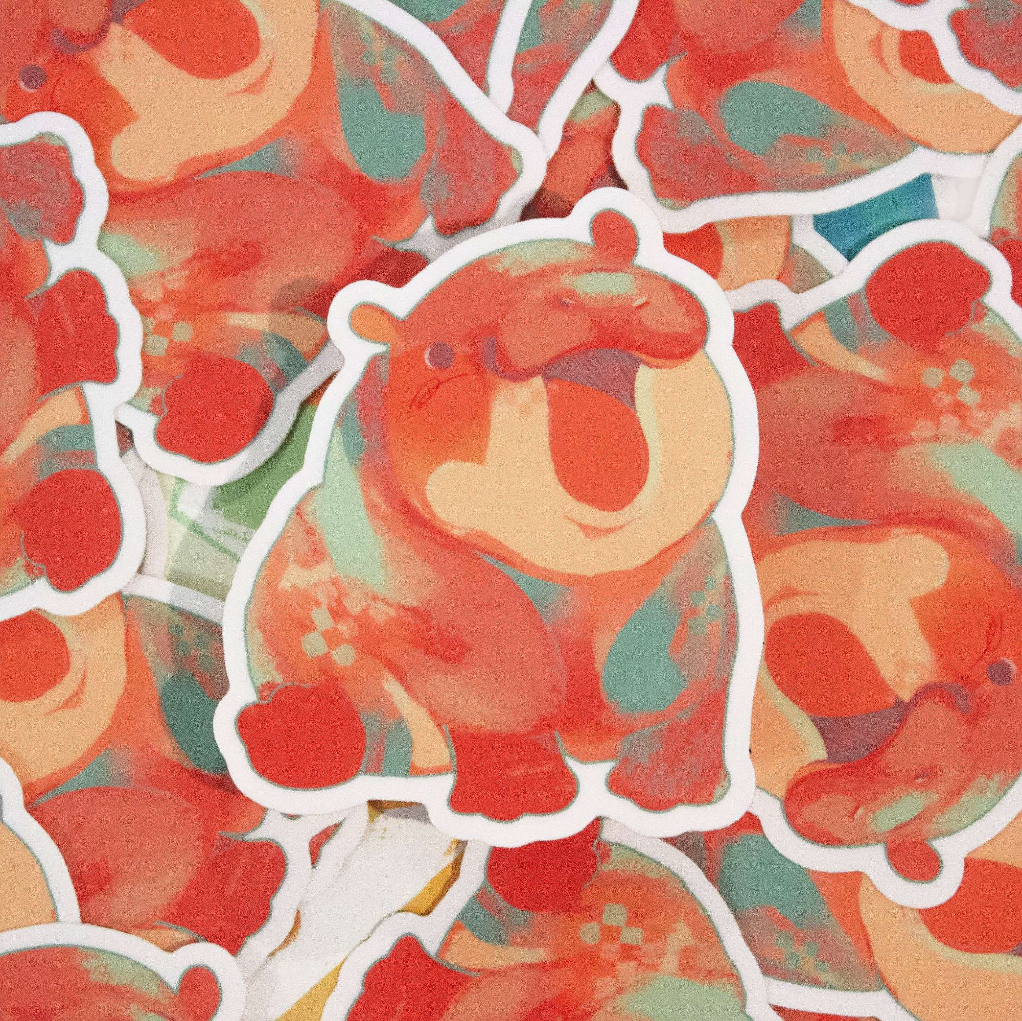 A vibrant, multi-coloured 3" hippo sticker, made out of a gloss vinyl material.