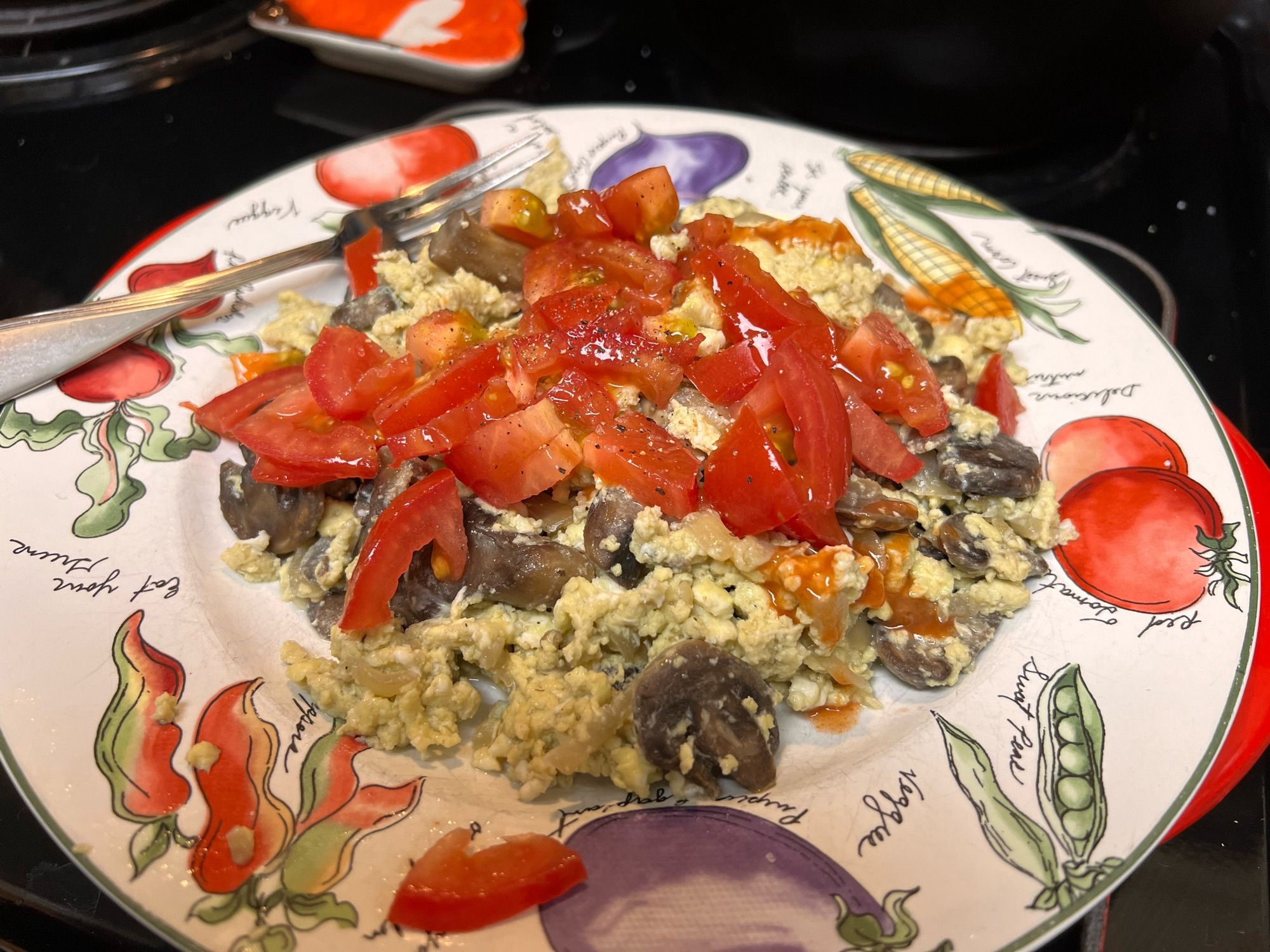 egg scramble with mushrooms, onion, and a diced tomato