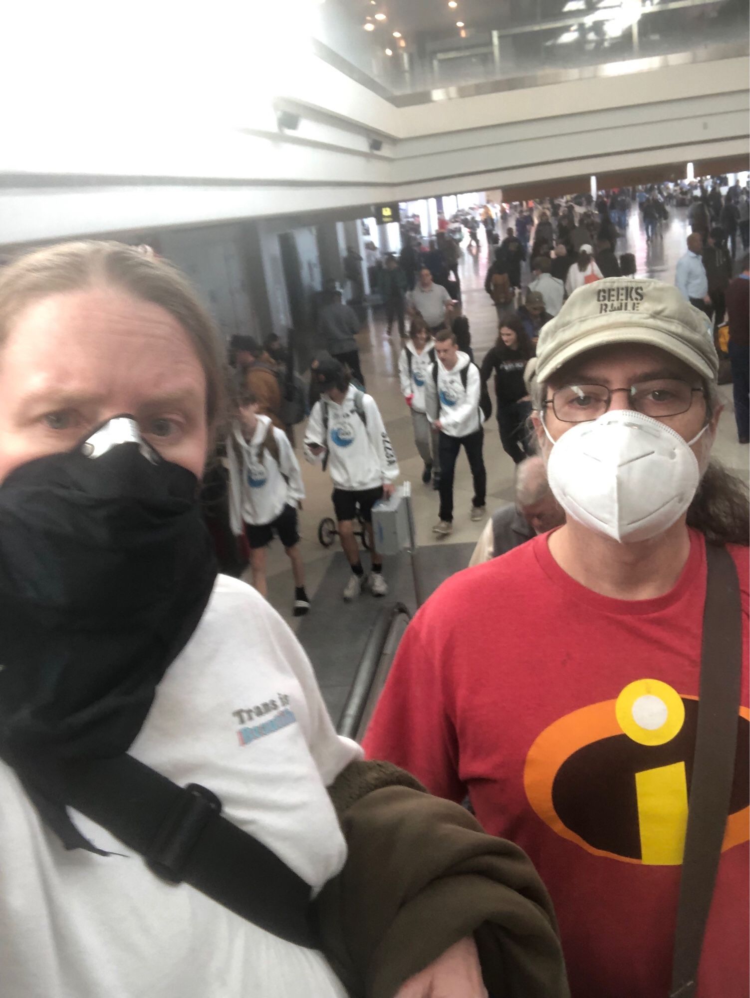 Photo of Sean and Jen in masks at the airport. 