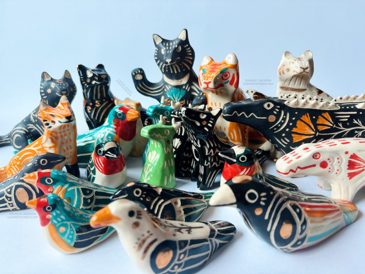 Group photo of my June/July pottery collection which consists of a large collection of birds, wolves, cat, and gator totems