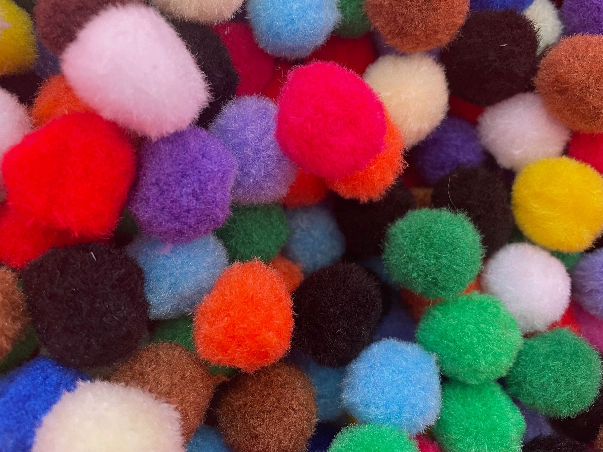 Close up of colourful pom poms