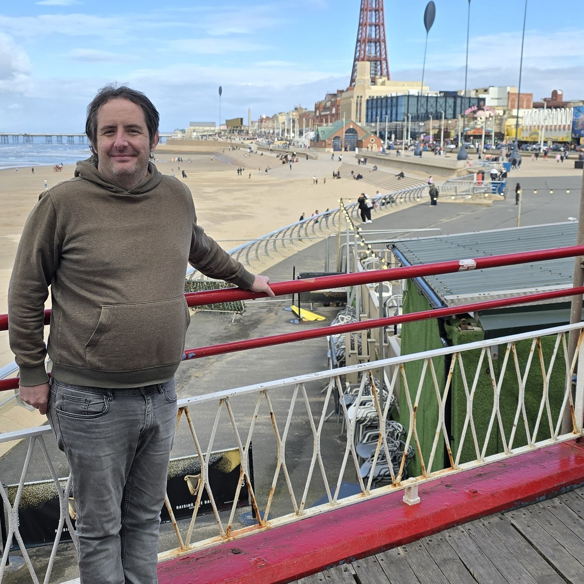 Me, standing on Blackpool Central Pier, with the beach and the tower in the background