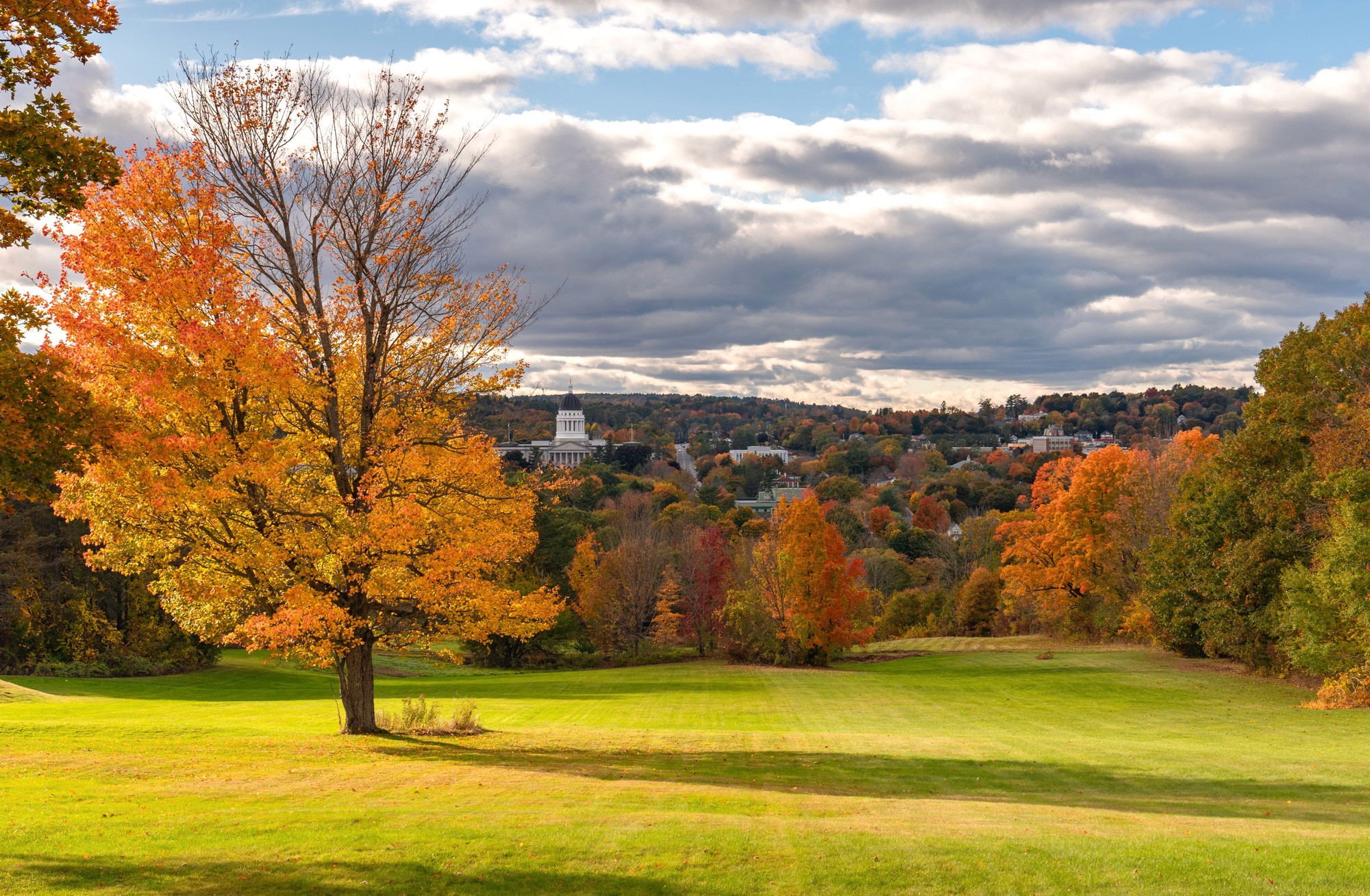 Fall colored trees around the Capitol building in Augusta, ME. 