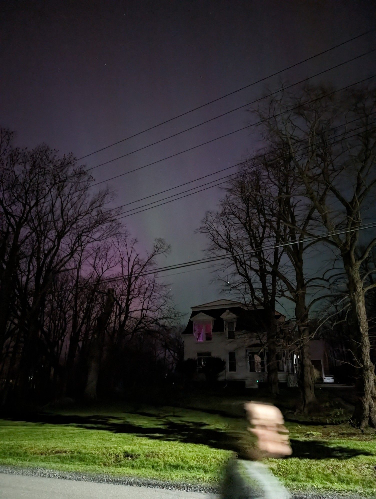 Northern lights over a house.