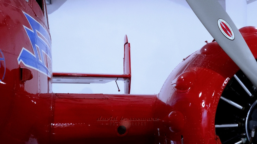 Title: Staring Down A ‘38
📱📷
Leading edge view, wing to left rudder, of a 1938 Beechcraft Model S18D.

The idle prop blade leaves you safely earthbound. You're the only thing moving. But, walk to either wing tip and settle your lens there. Focusing back toward the fuselage, you may immediately feel the ground rushing away from your feet. 
Beechcraft Heritage Museum, Tullahoma, TN USA. 

#MondayRed #ColorfulMonday #motorheadmonday #machinemonday #originalcontent #photographerlife #shareyourparadise #samsung #S23Ultra