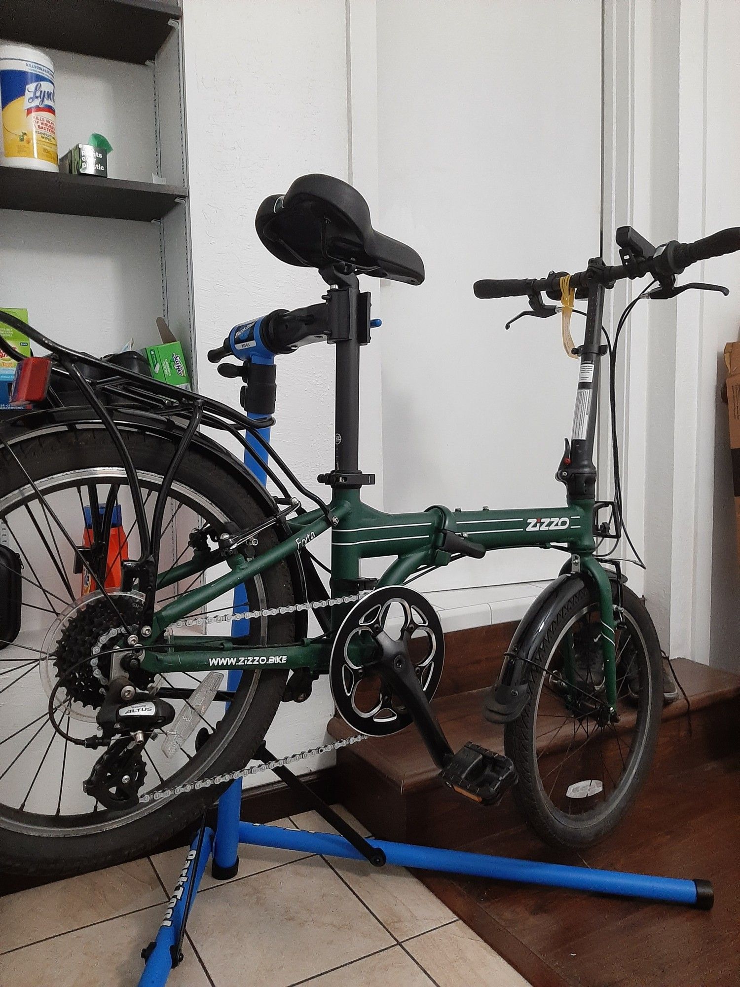 A folding bike mounted on a repair stand.