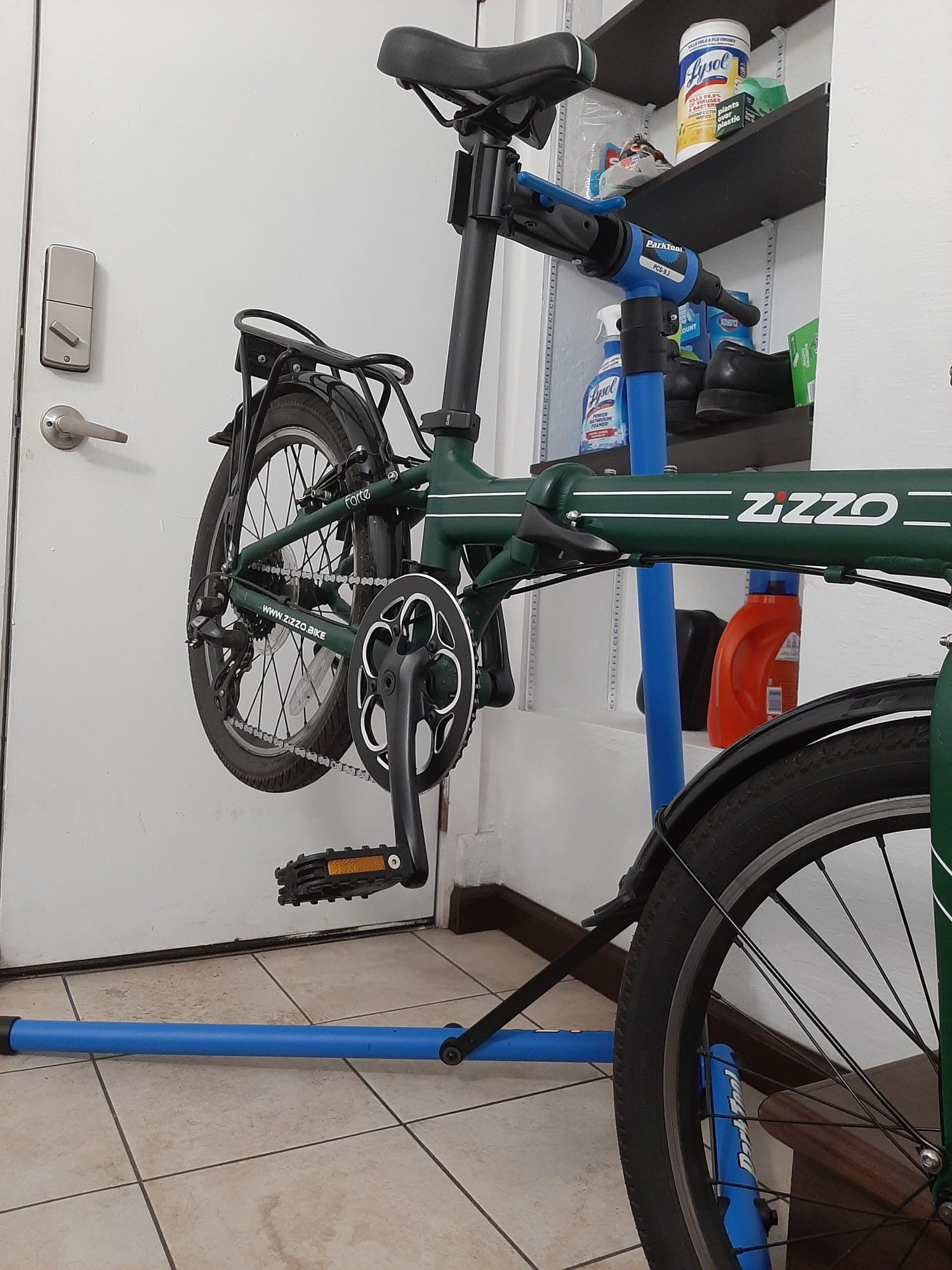 A folding bike mounted on a repair stand.