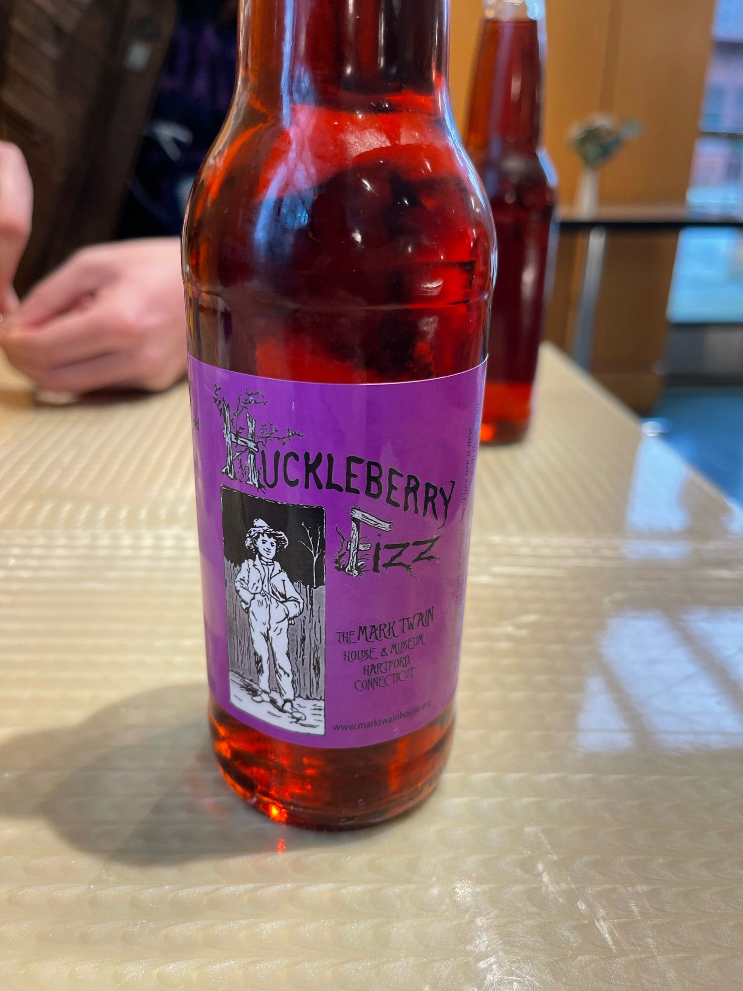 Huckleberry fizz soda bottle with an image of Huckleberry Finn inside the museum cafe