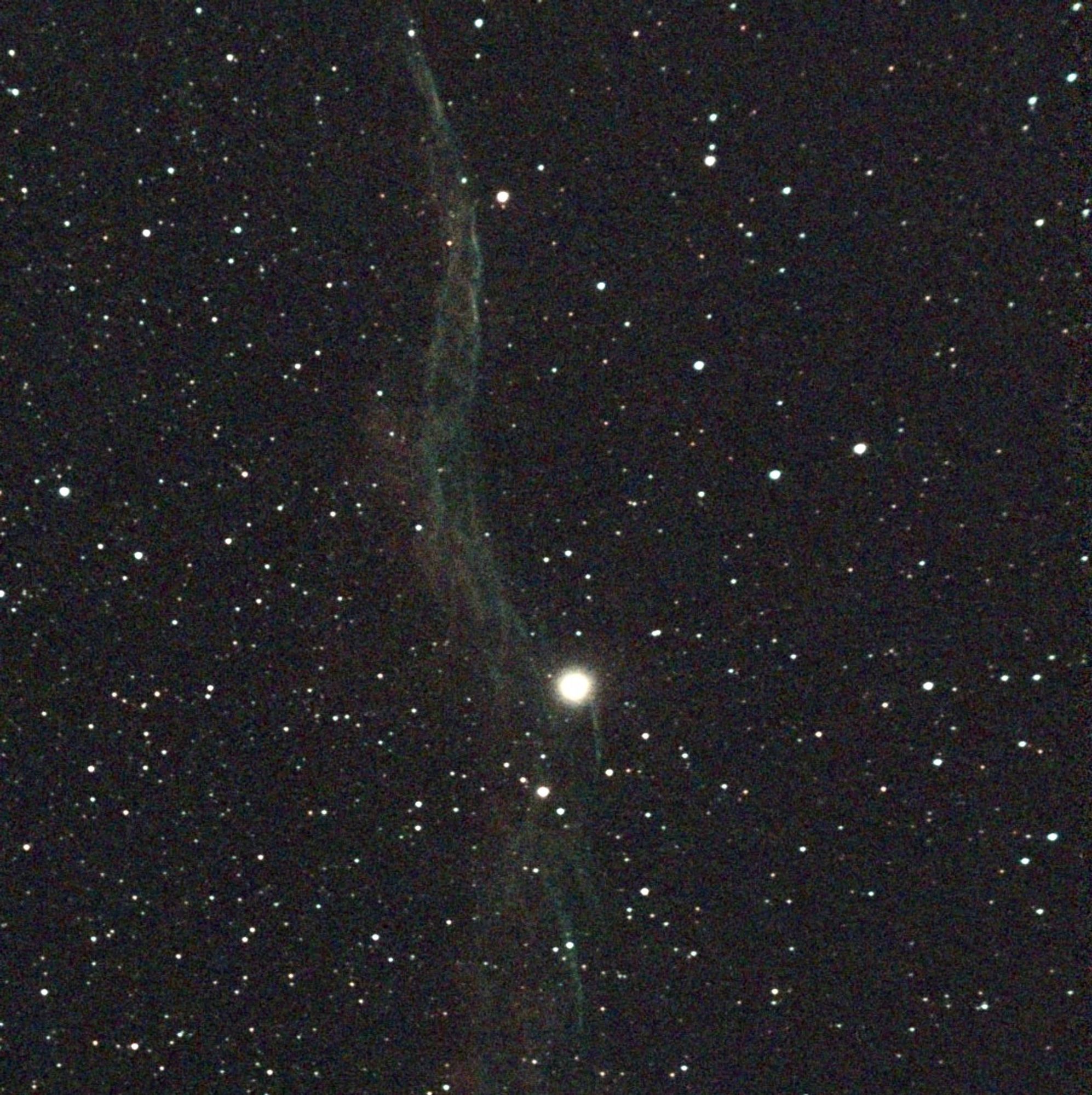 The Eastern Veil nebula, a long vertical lacy streak.