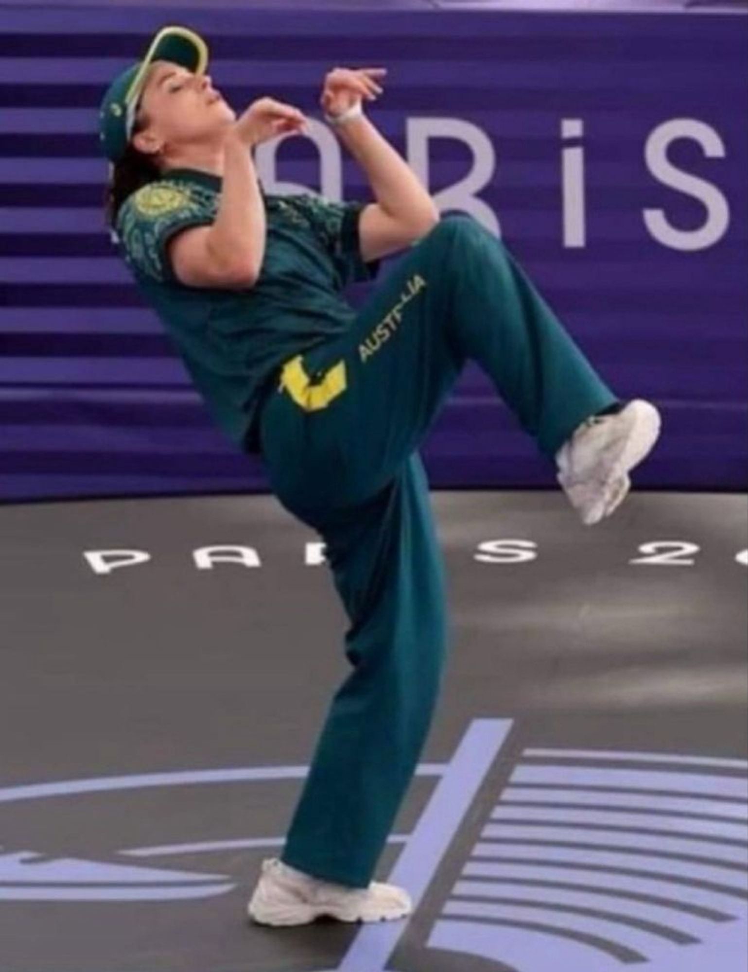 Womens breakdancing preforming an 'emu' move during competition