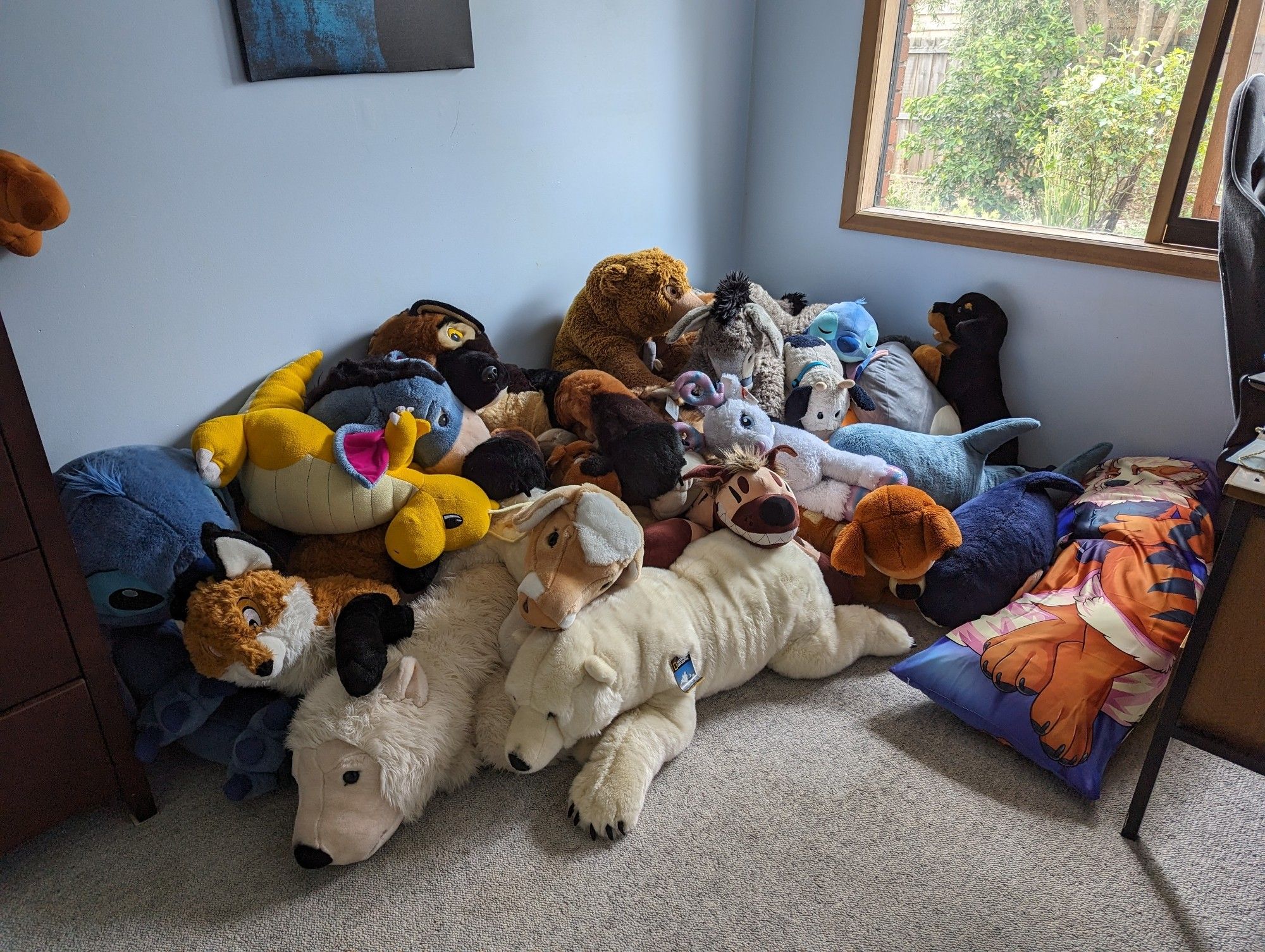 Pile of various plush toys big enough for a person to sleep amongst.