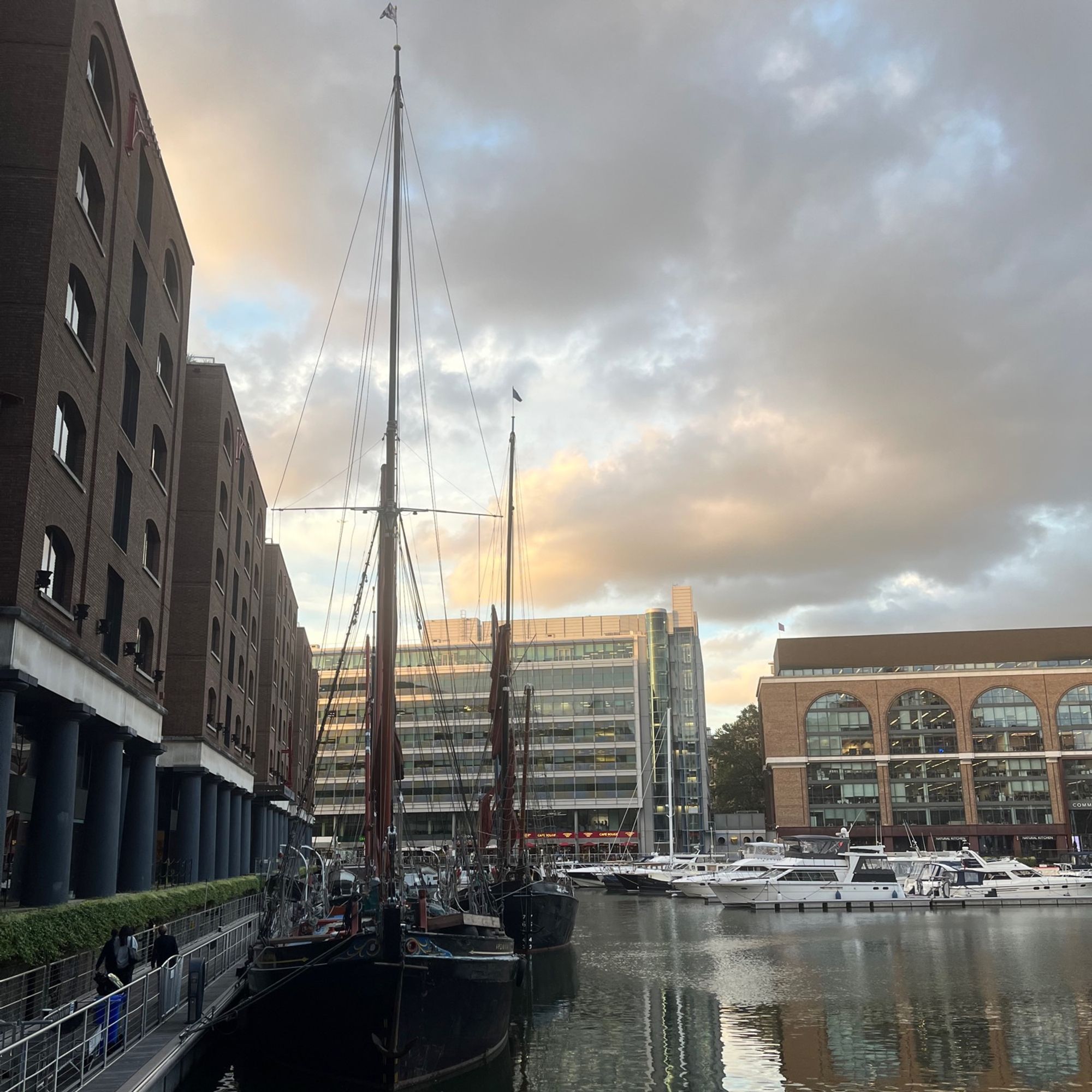 Tall ship docked in St Katherine’s Dock with the beginnings of sunset in the background