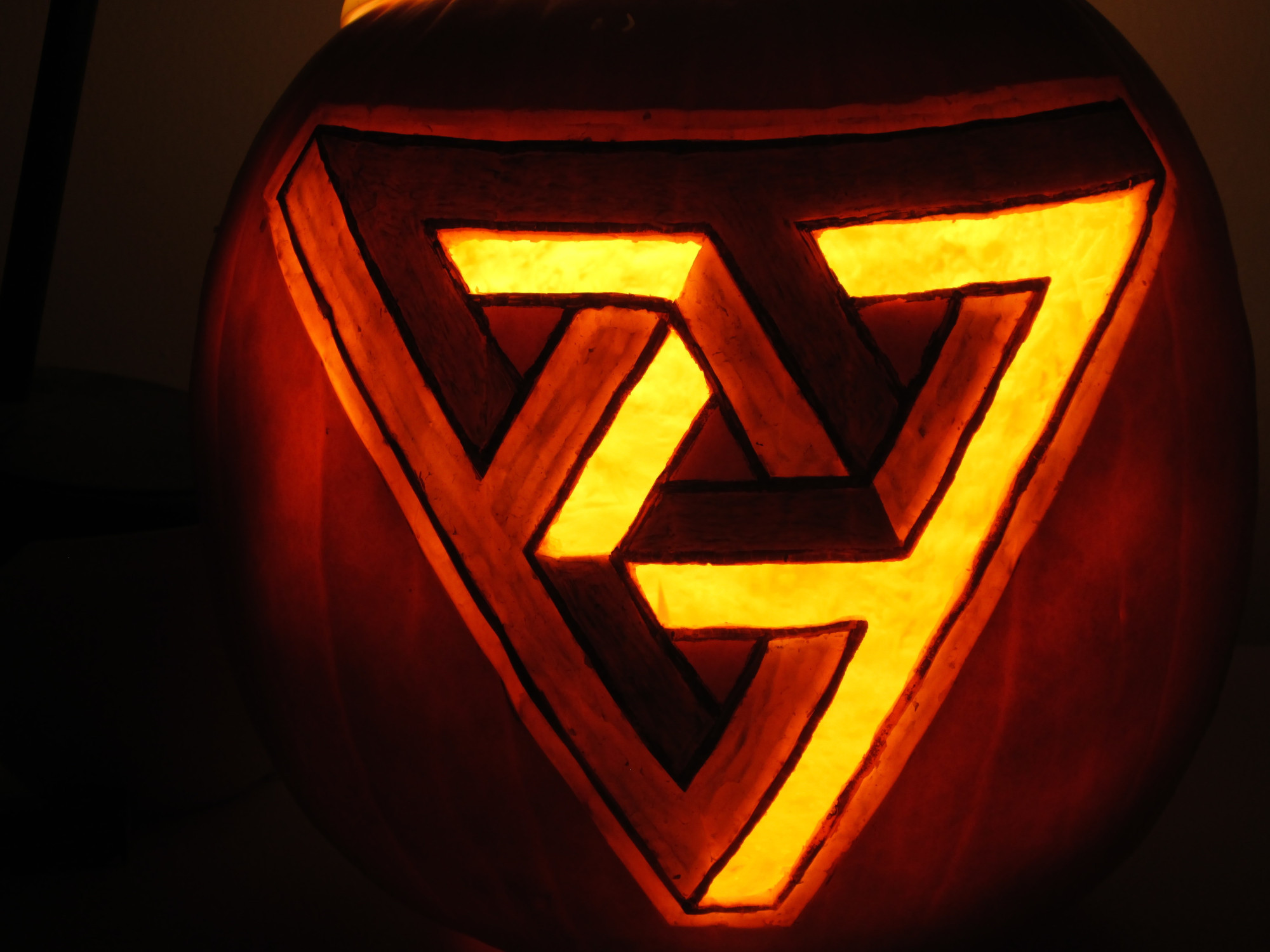 Penrose triangle Jack-o'-lantern. Pumpkin with a Penrose triangle carved into it.