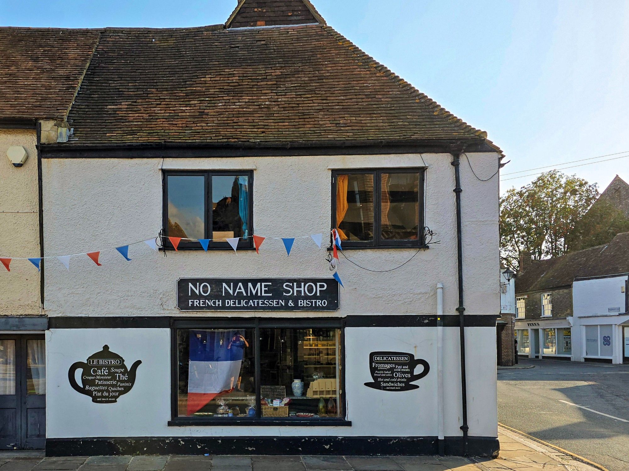 The No Name Shop with its white stucco walls stands in the middle of town in Sandwich, Kent.