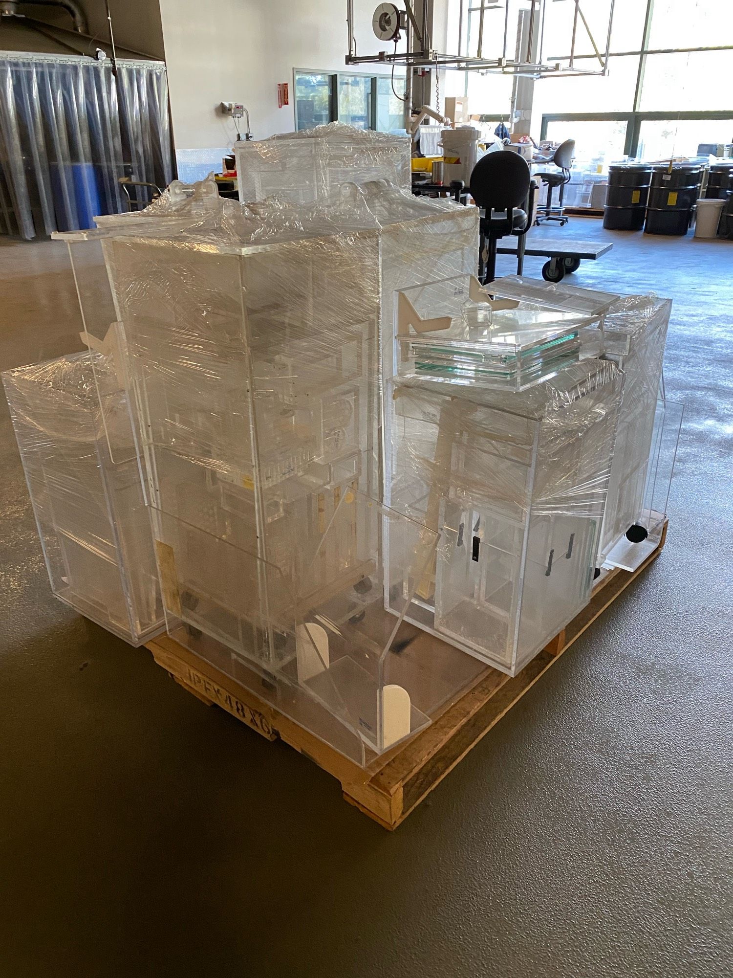 A pallet of cling wrapped lucite objects for beta shielding.