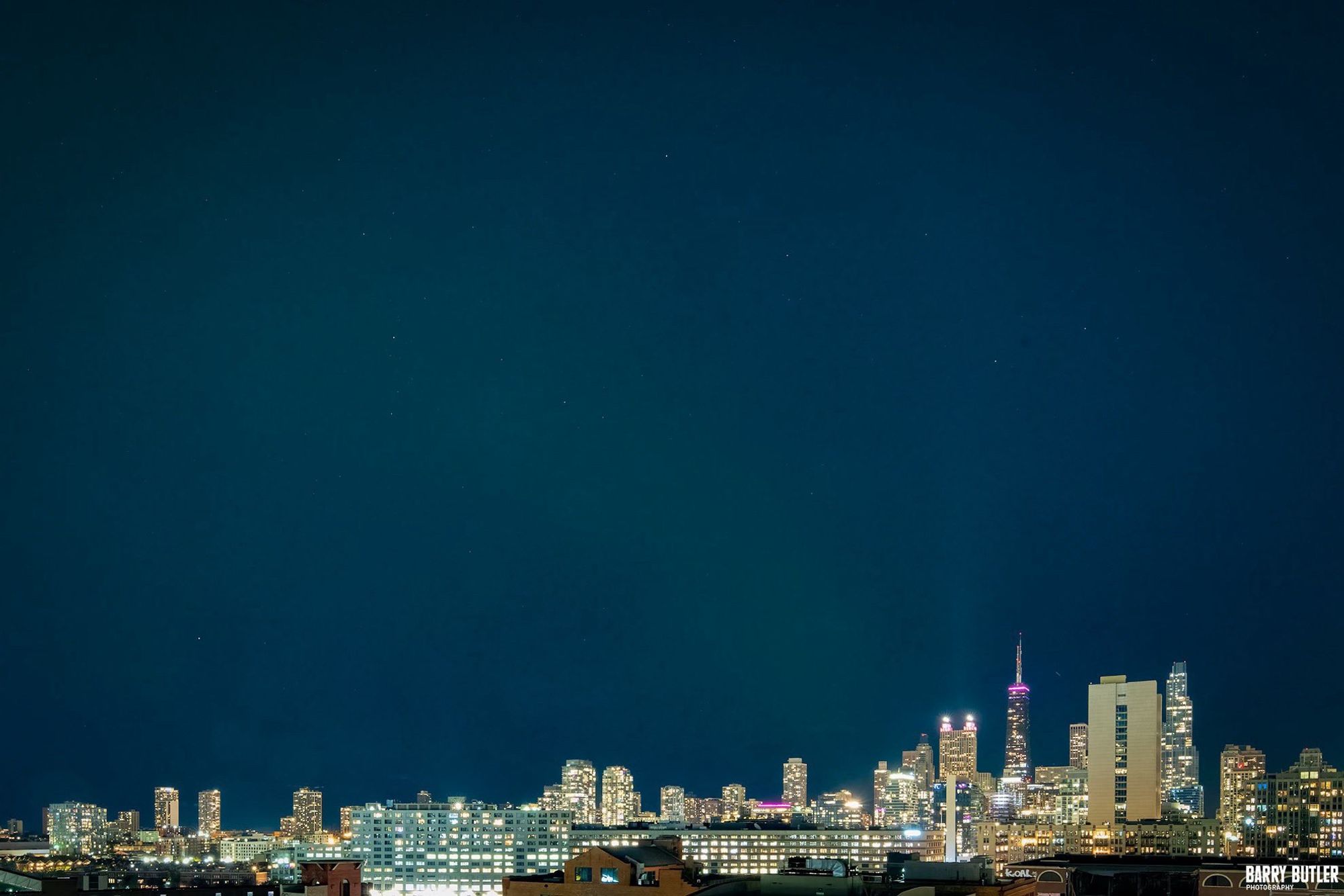 The night sky over downtown Chicago. You can see a fate green hue in the blue.