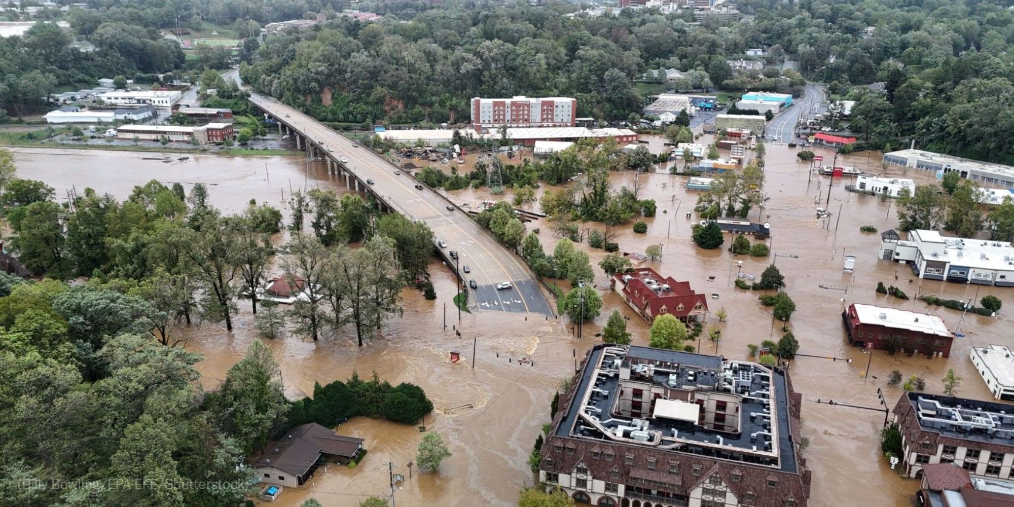 Flooding covers streets in Asheville on Friday. Photo by Billy Bowling for EPA-EFE/Shutterstock.