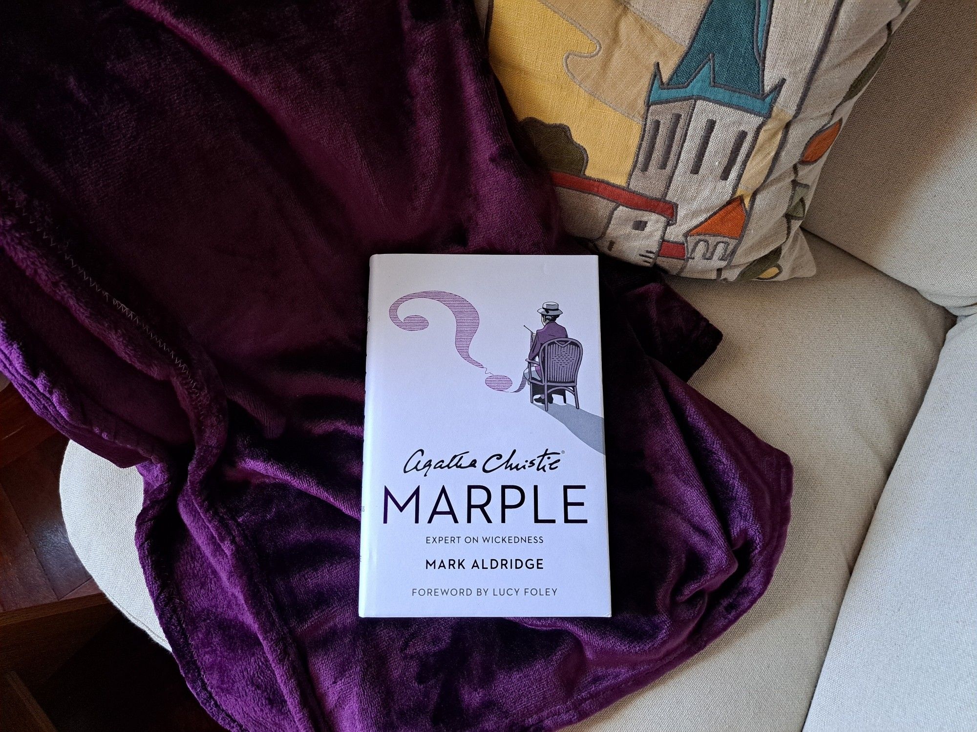 The book Marple over a lilac blanket