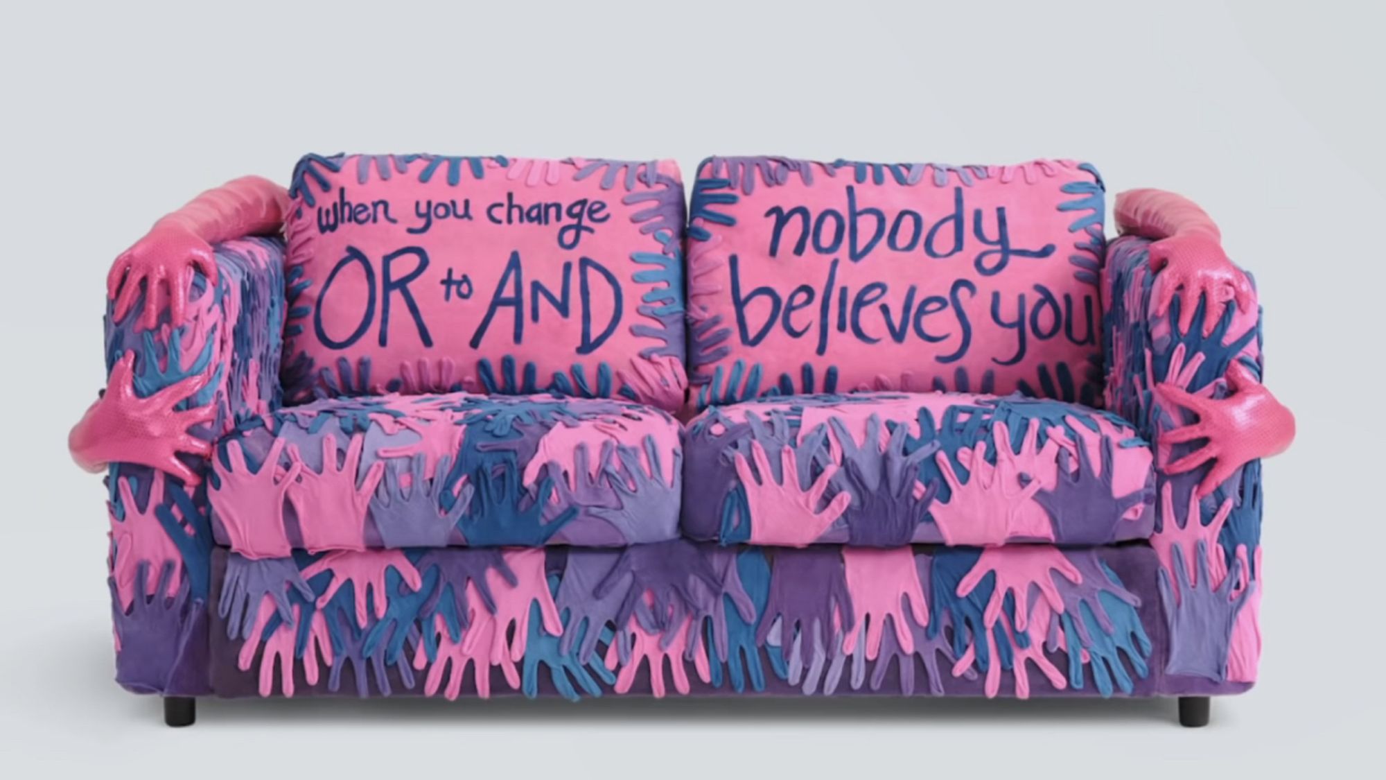 Couch created as part of an IKEA Pride installation in 2021, each depicting a different lgbtq+ identity. This particular couch is meant to celebrate being bisexual, but instead comes off as terrifying. The couch is covered in hands, in the colors of the bi pride flag, and includes the text “when you change OR to AND nobody believes you”