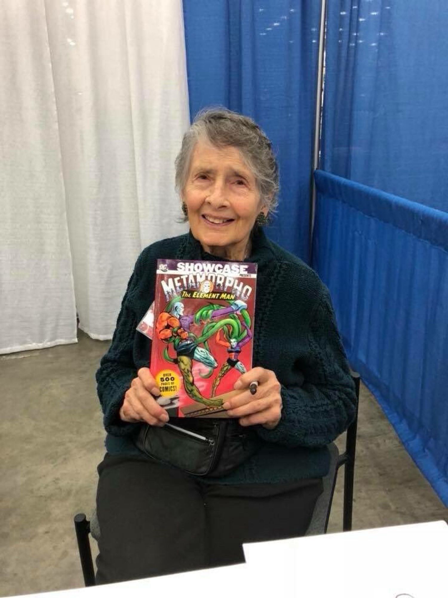 Photo of Fradon holding a collection of Metamorpho stories