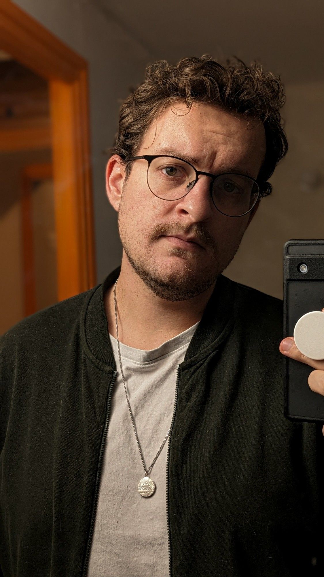 Selfie miroir en veste verte t-shirt blanc et un collier en argent