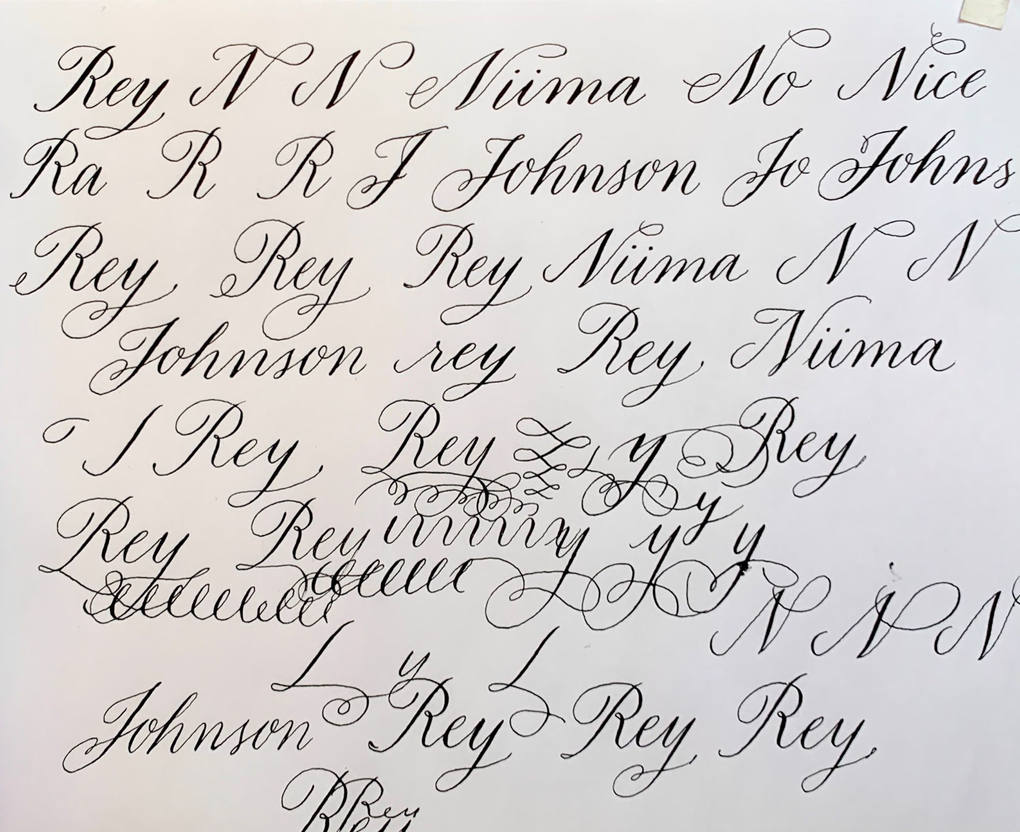 “Rey Niima-Johnson” written over & over in sketchy calligraphy practice