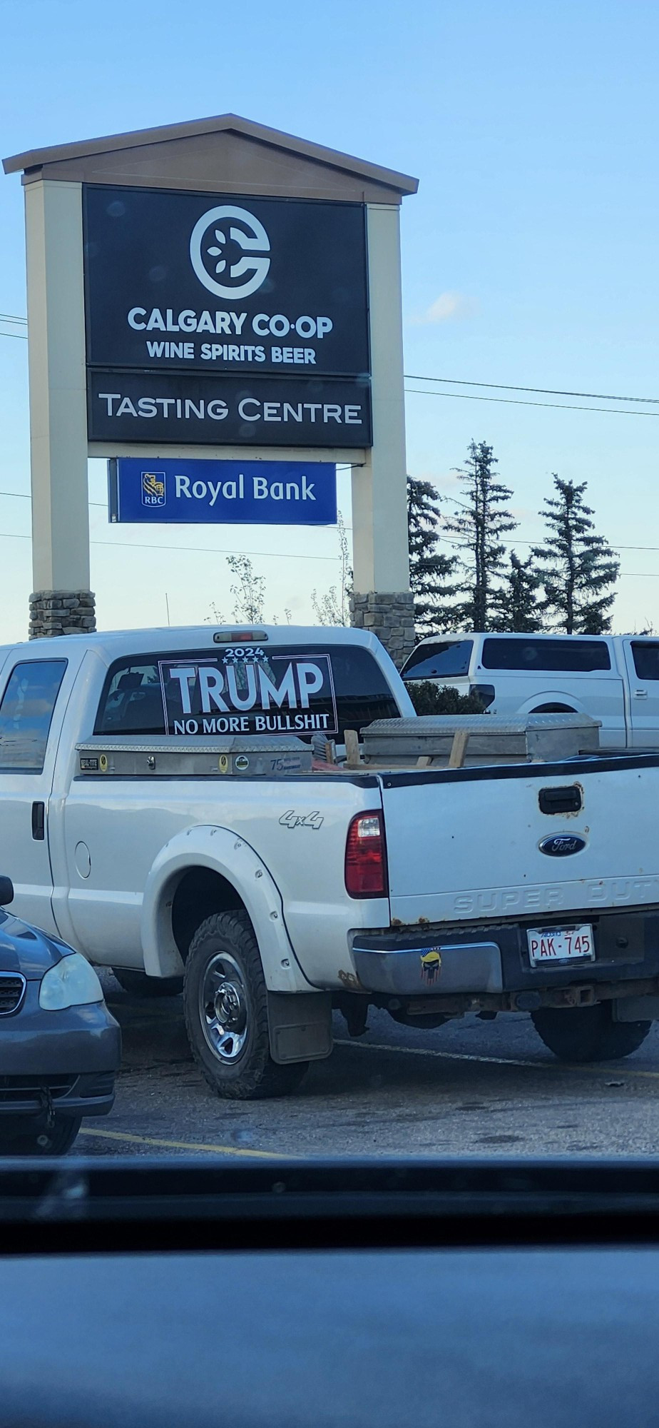 White pickup truck park in front of Calgary Co-op sign

Rear window of pickup has message: TRUMP - No more bullshit