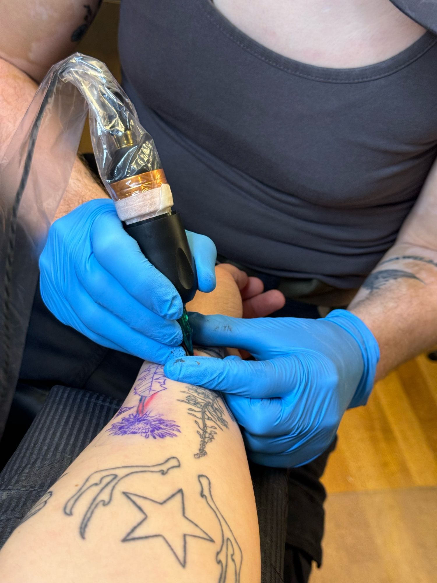 Andrea’s arm in the middle of getting tattooed