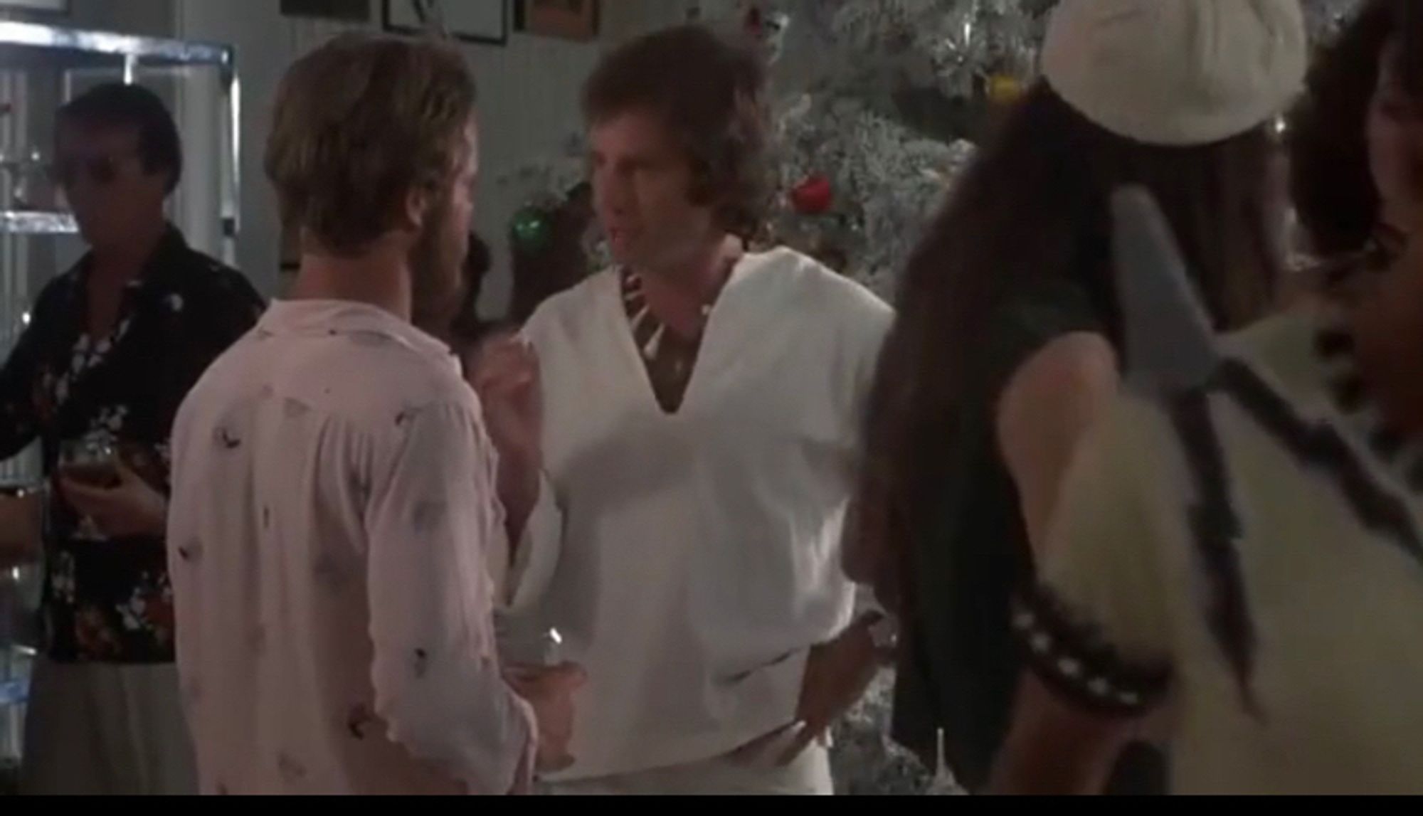 In a shot from the Hollywood party scene in Annie Hall, two young white men talk.