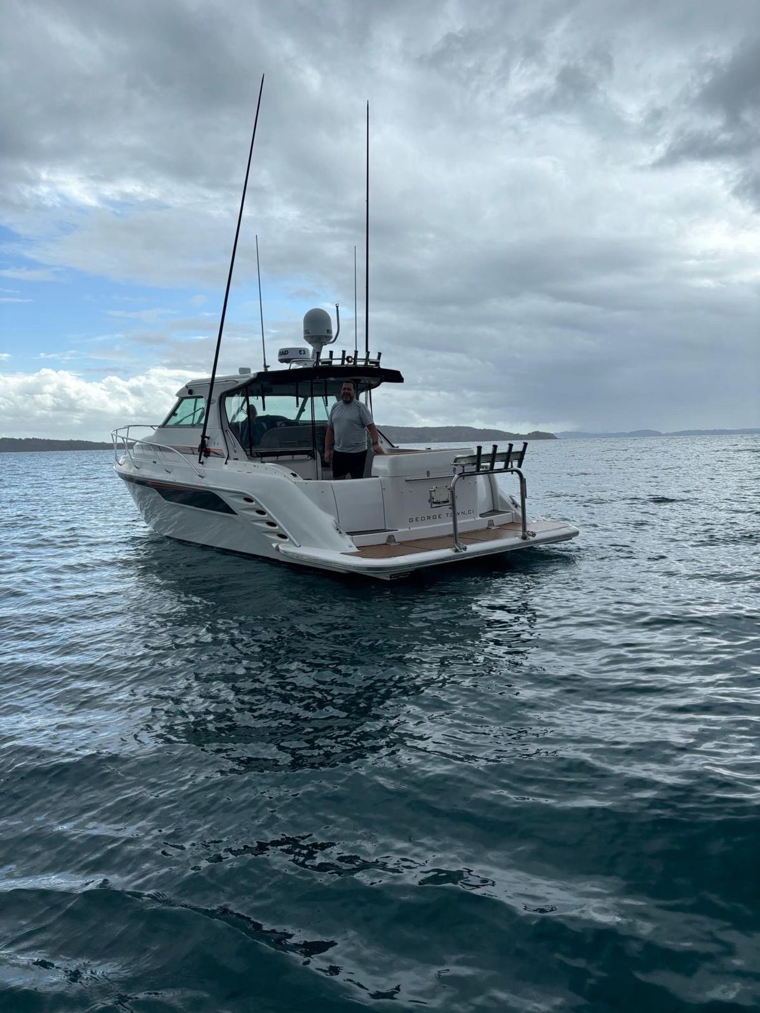 Me on the”new” boat - a Rayglass 4000 (41ft / 12m launch) with Whangaparaoa peninsula in the distance. Sea is calm as we are in the shelter of Tiritiri Matangi island. Pic was taken from the coastguard boat