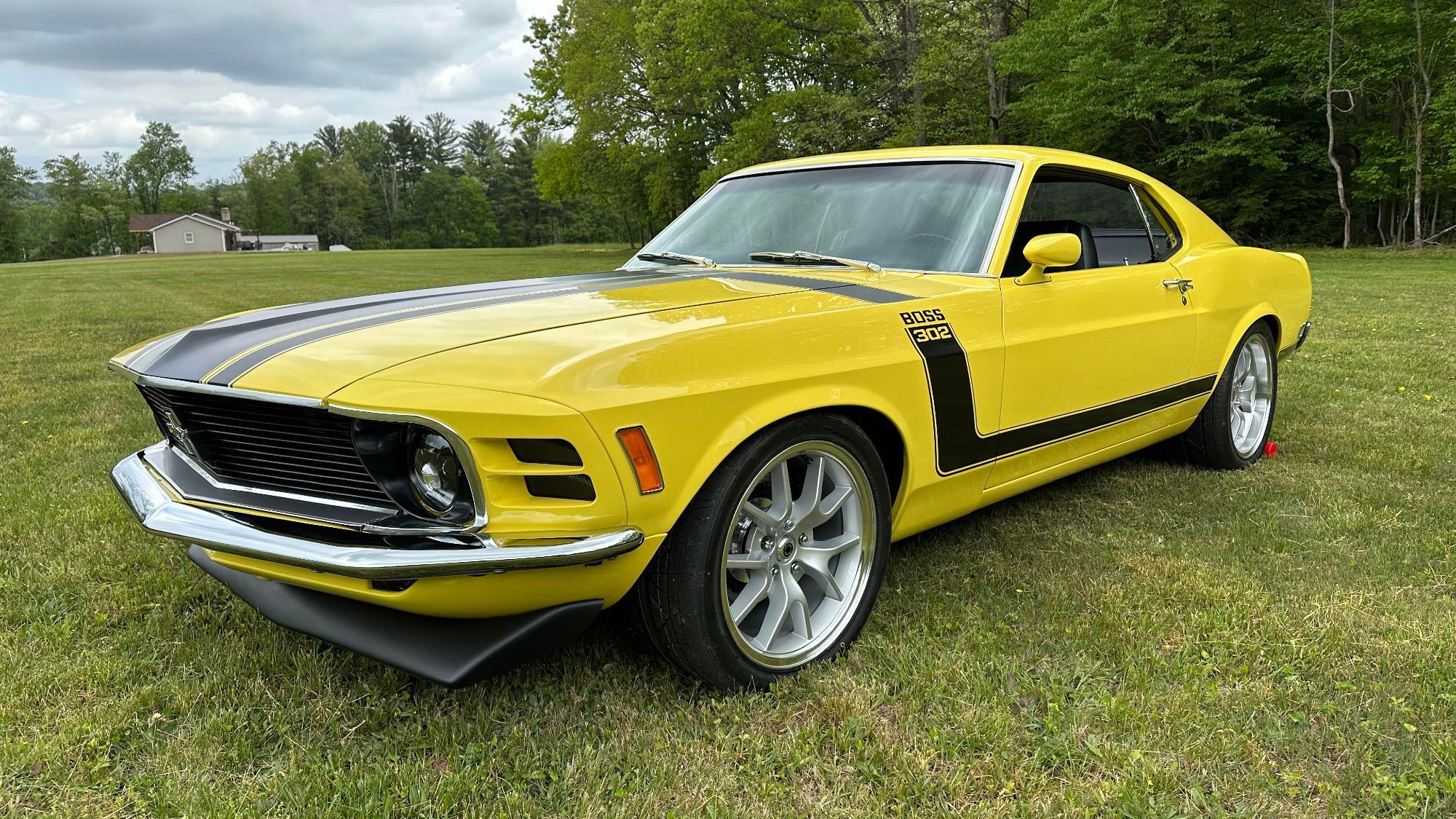 A yellow and black 1970 Ford Mustang Boss 302 Fastback.