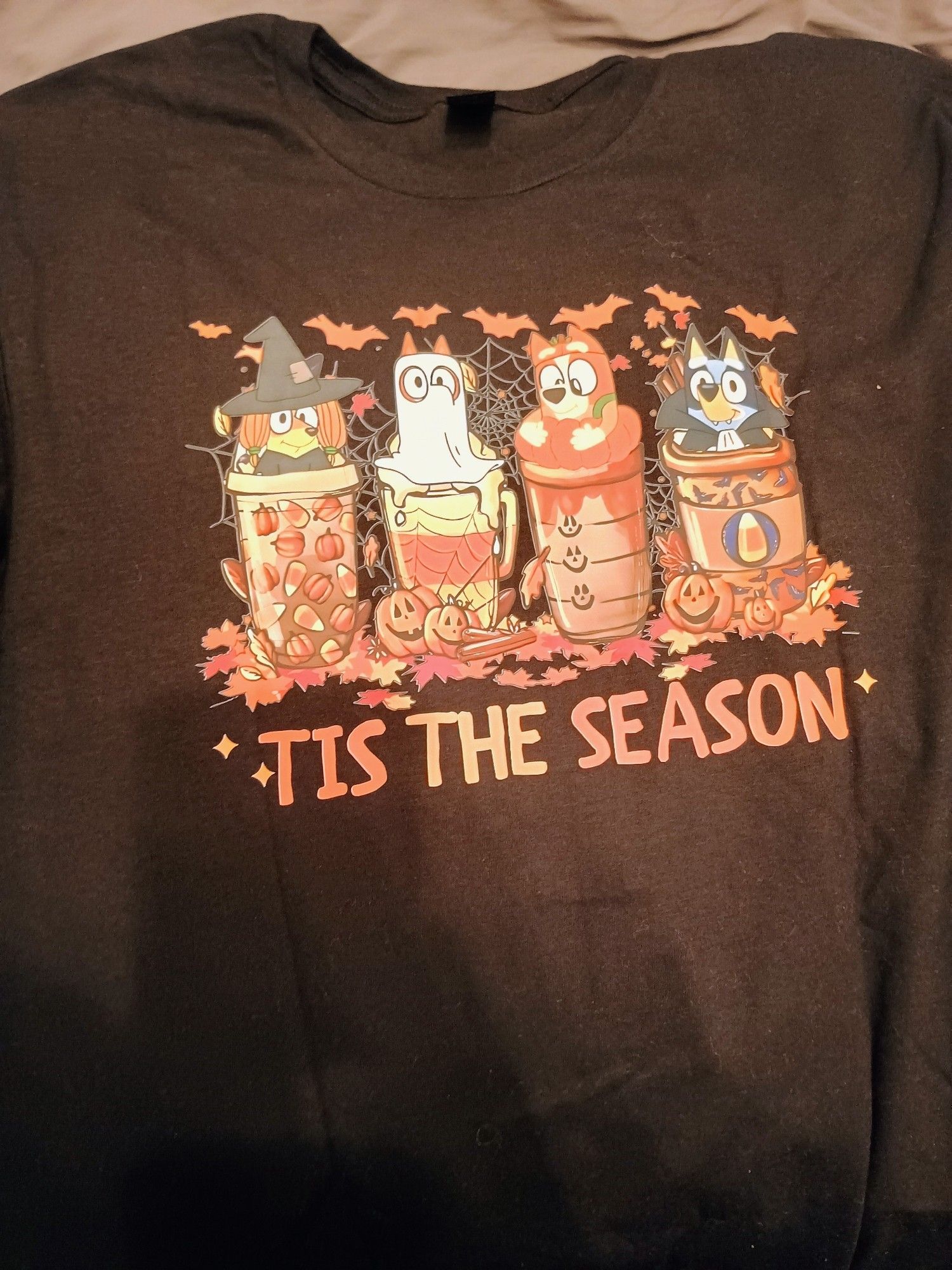 Bluey shirt that says Tis the Season with the characters in Halloween costumes.