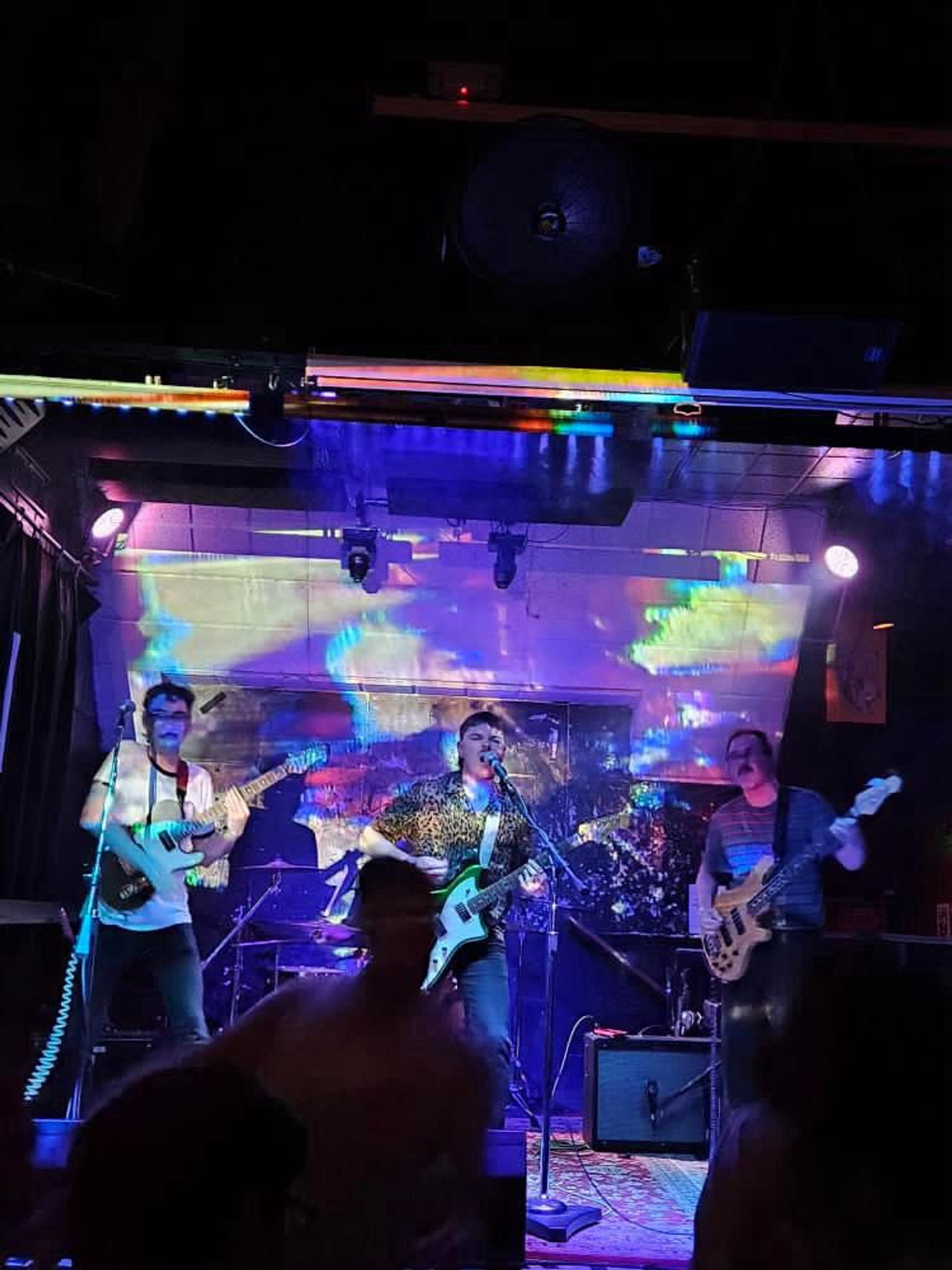 The same, but the image being glitched shows the band performing