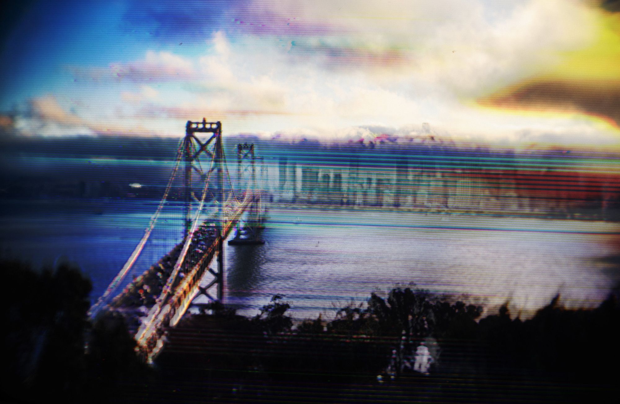 Image of a glitched out bay bridge at sunset with shaky lines as the supports, and a blue and orange sky